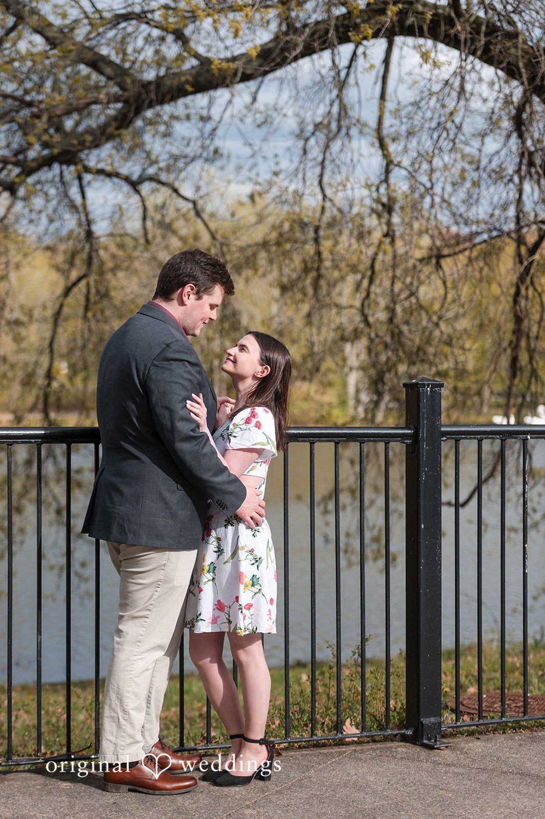 Couple embracing while looking at each other  near lake at Roger Williams Park