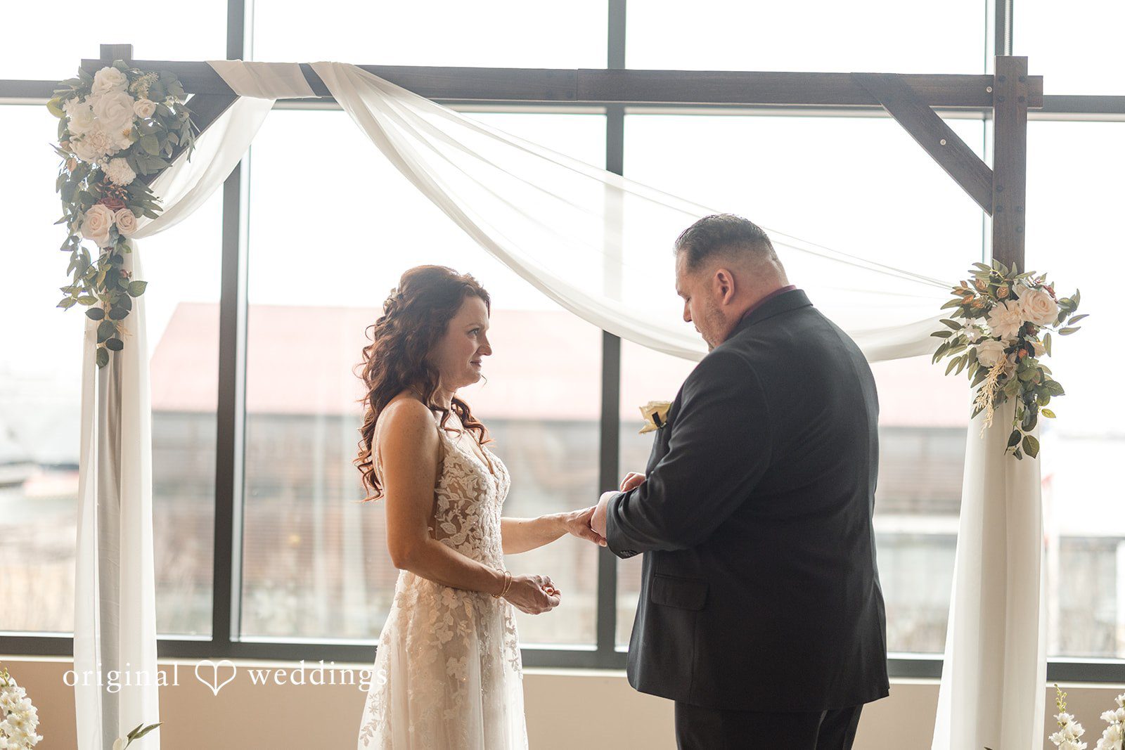 Beautiful wedding ritual of groom sliding ring onto bride’s finger