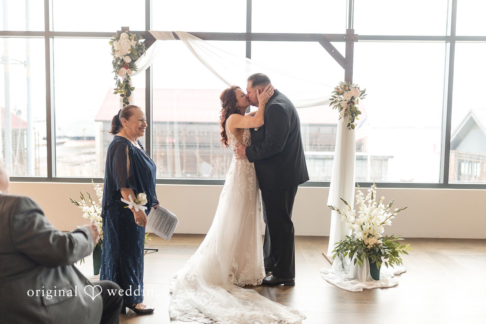 Emotional wedding kiss moment of bride and groom