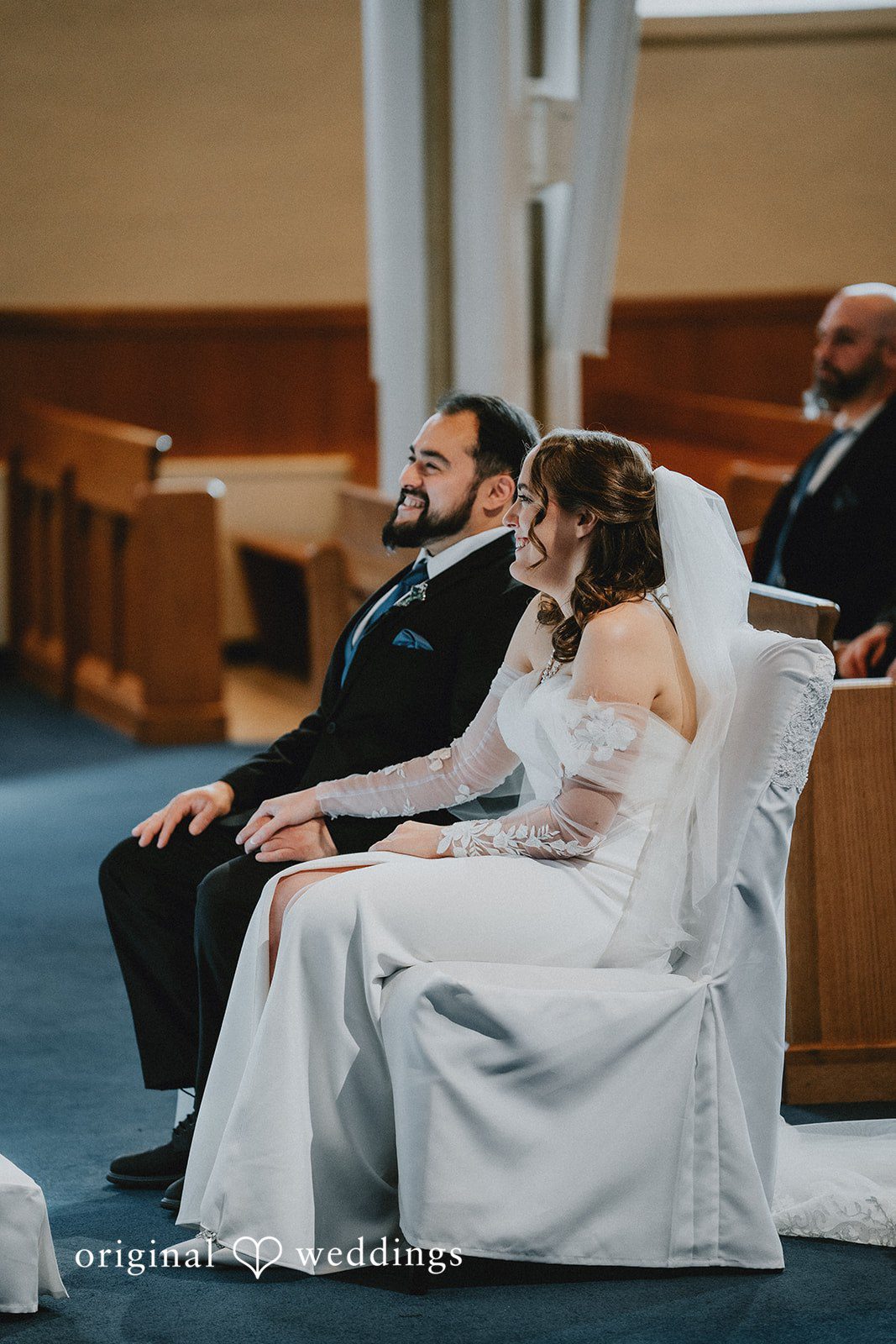 Mary + Ryan Couple seated at chairs during ceremony