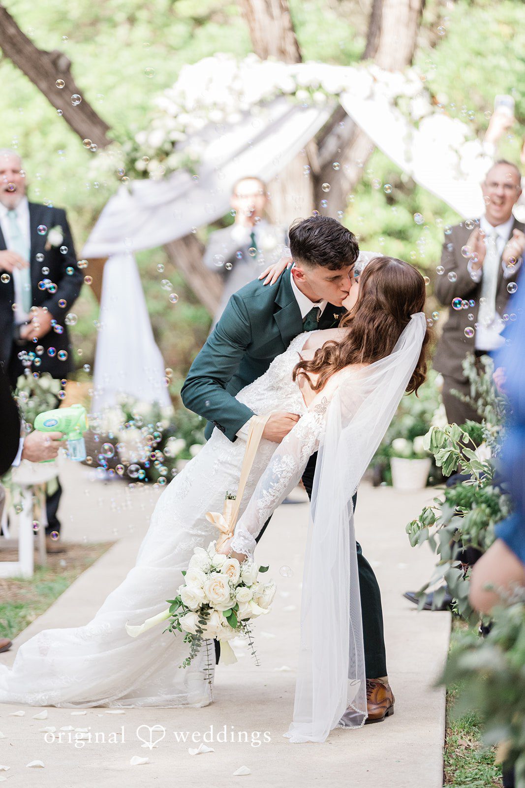 Gavin + Kayleigh The couple shares a romantic kiss at the aisle