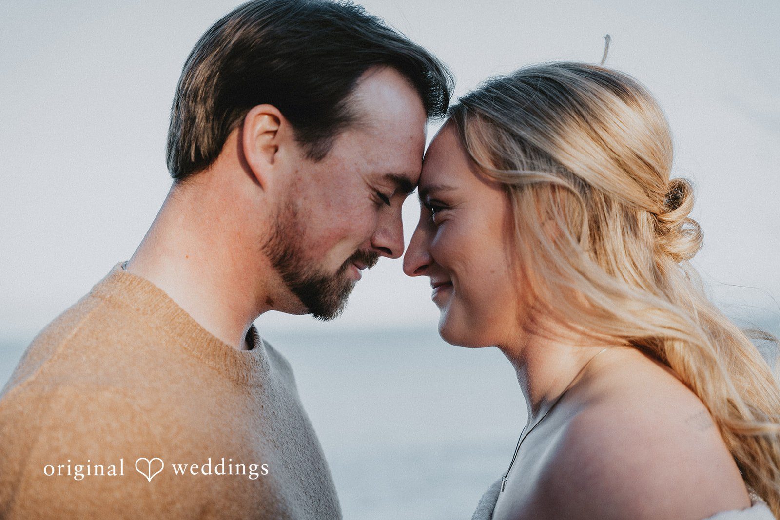 An intimate close-up of the couple touching foreheads and smiling