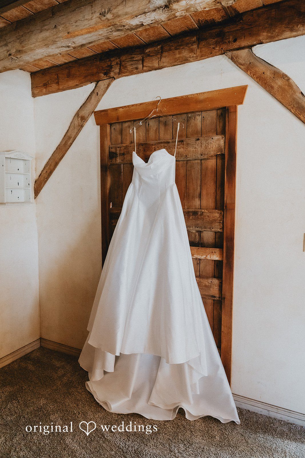 Elegant wedding dress hanging inside Shenandoah Mill