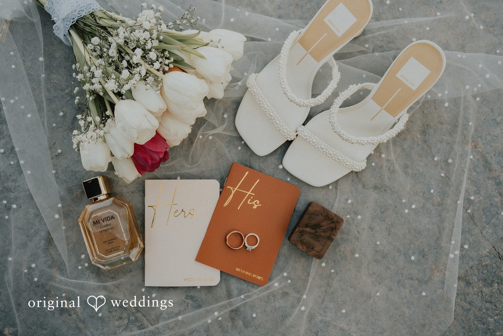 Wedding rings perfume bridal shoes and bouquet styled together for elegant wedding detail photography