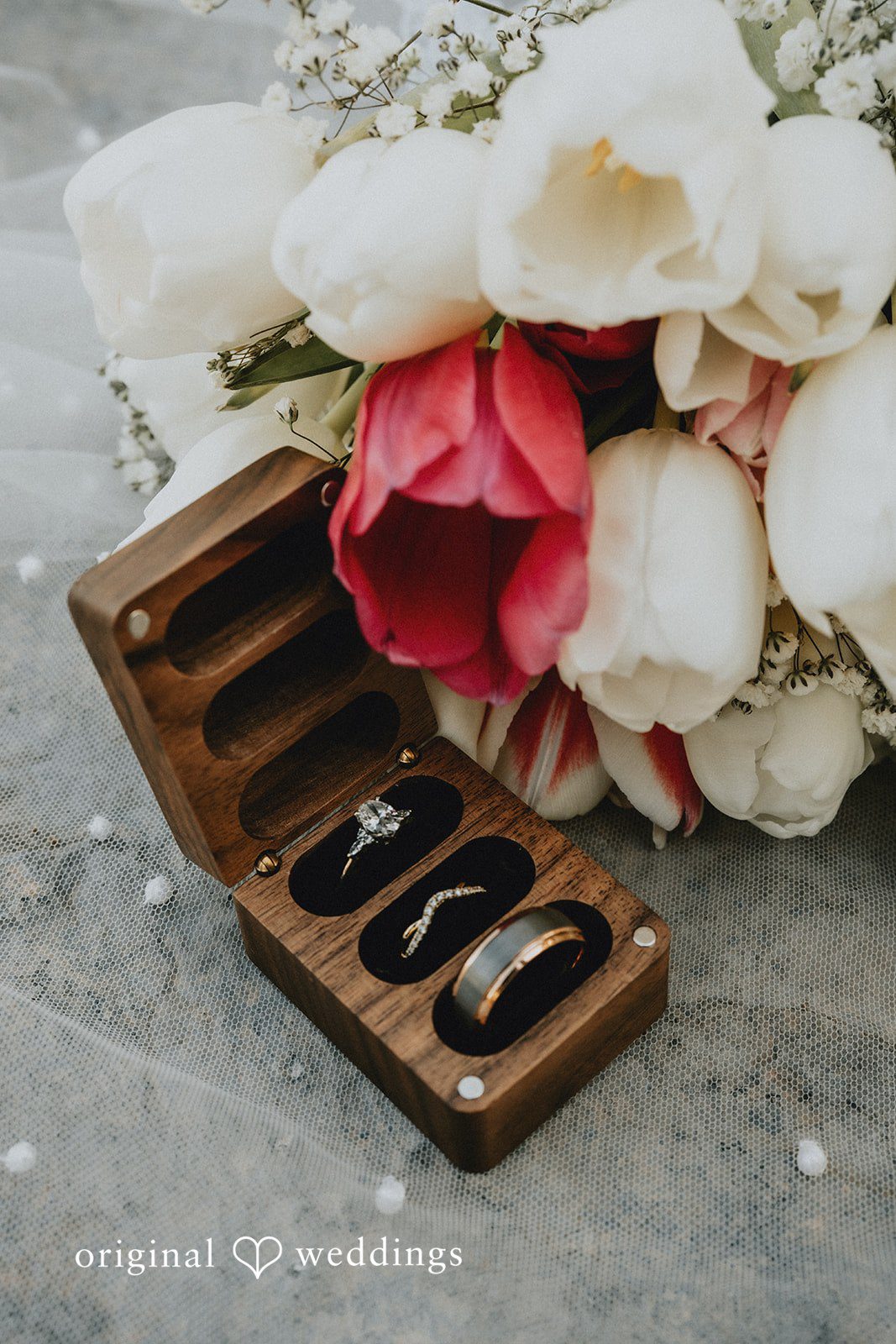 Beautiful wedding ring detail shot with floral bouquet at Shenandoah Mill