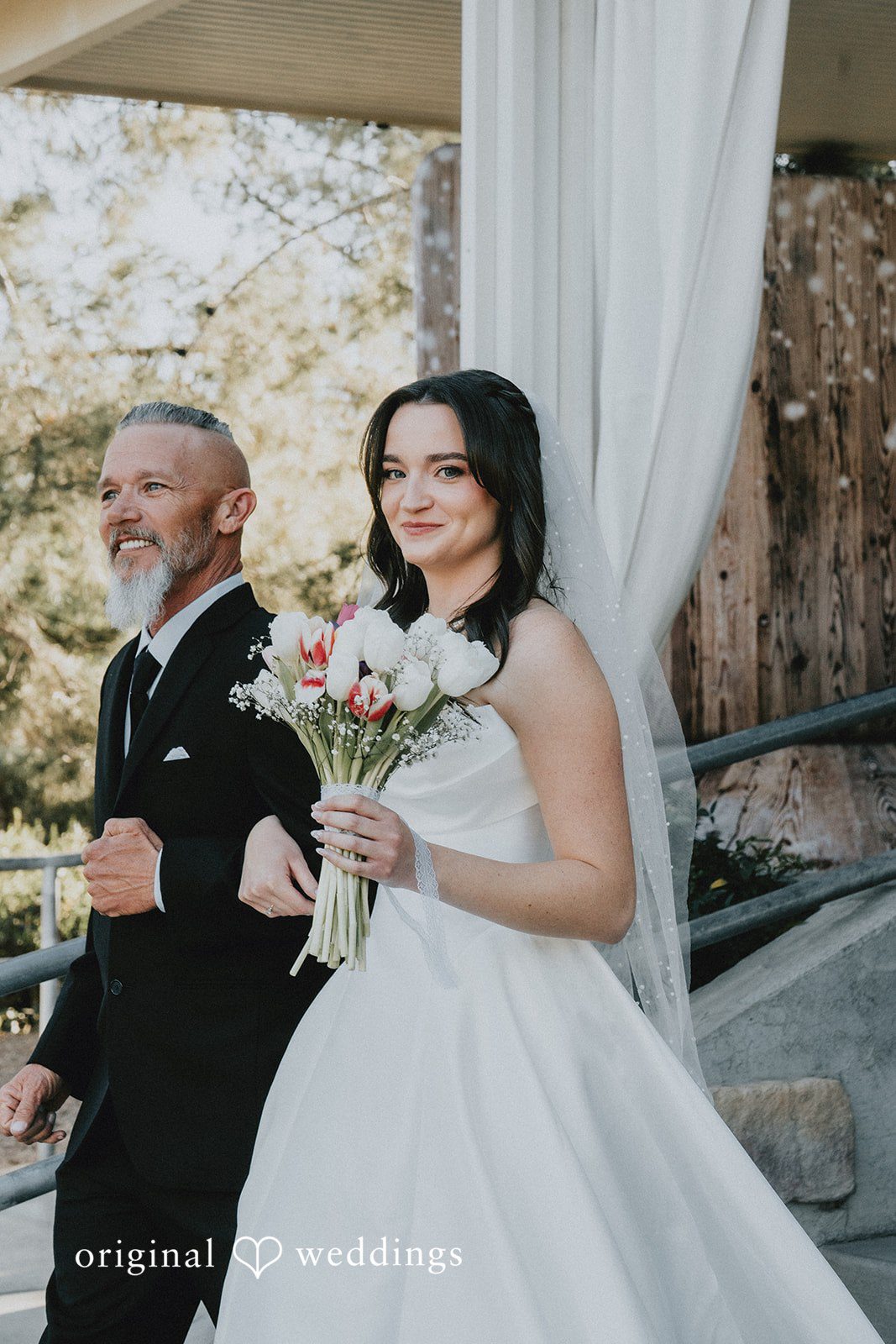 Bride carrying bouquet while walking for ceremony