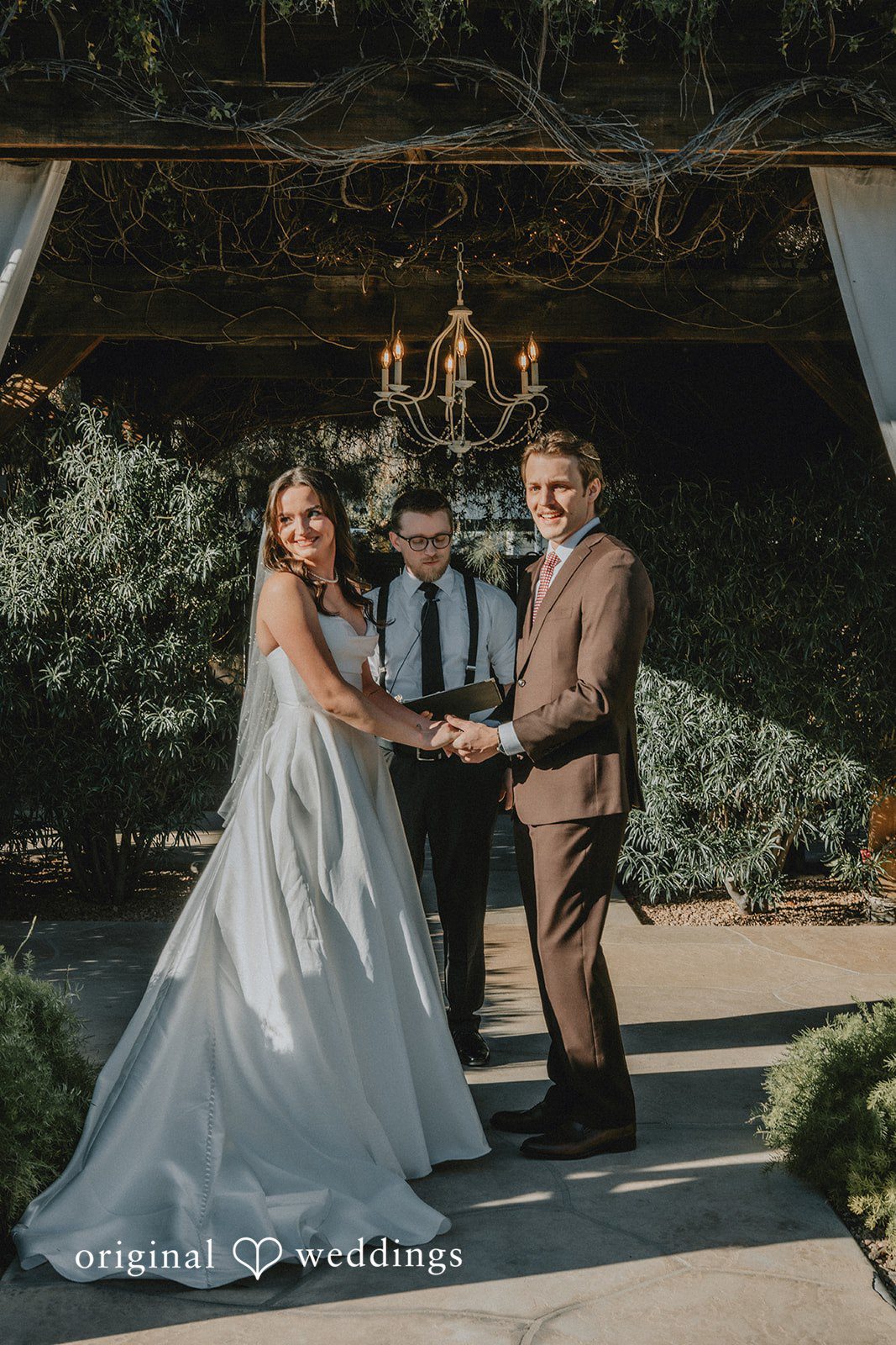 Bride and groom holding hands during wedding ceremony at Shenandoah Mill