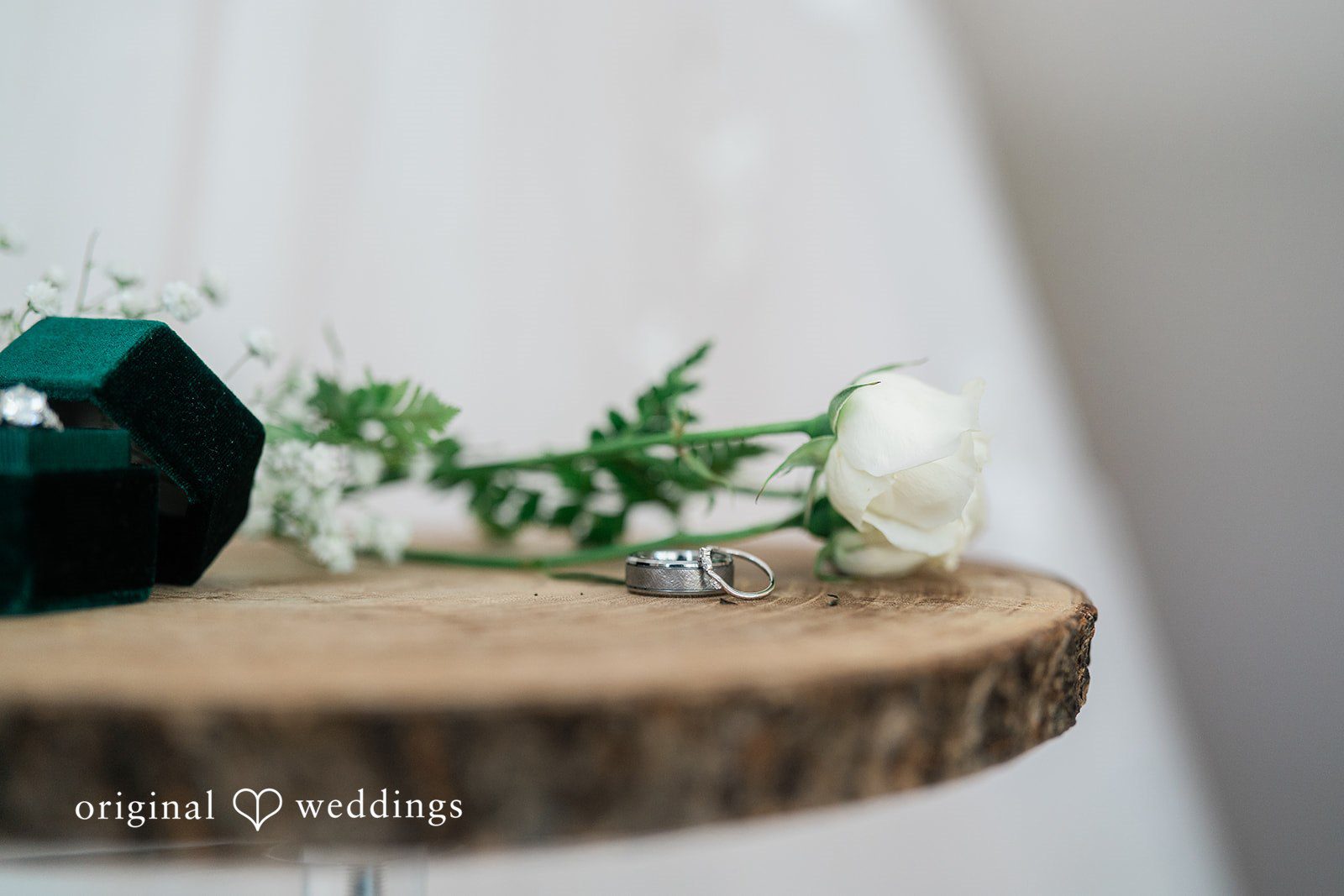 A detail shot of the wedding rings and bouquets