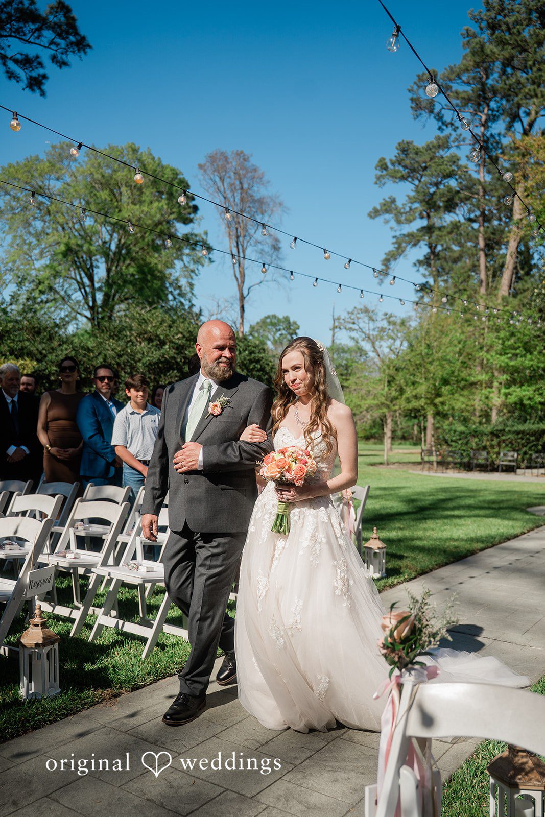 The bride's father walks the bride down the aisle