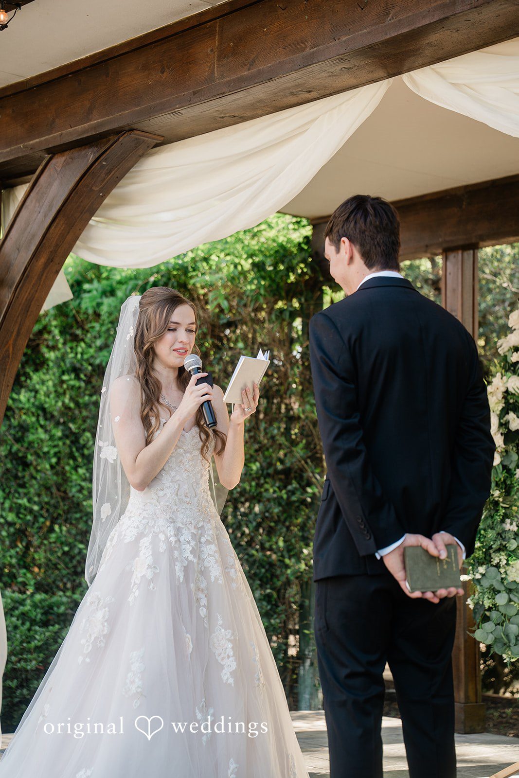 The bride reads her vows to the groom