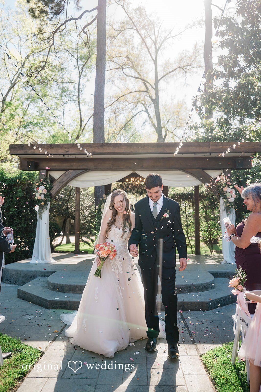 Our Houston wedding photographers captured the couple making a joyful exit after their wedding ceremony