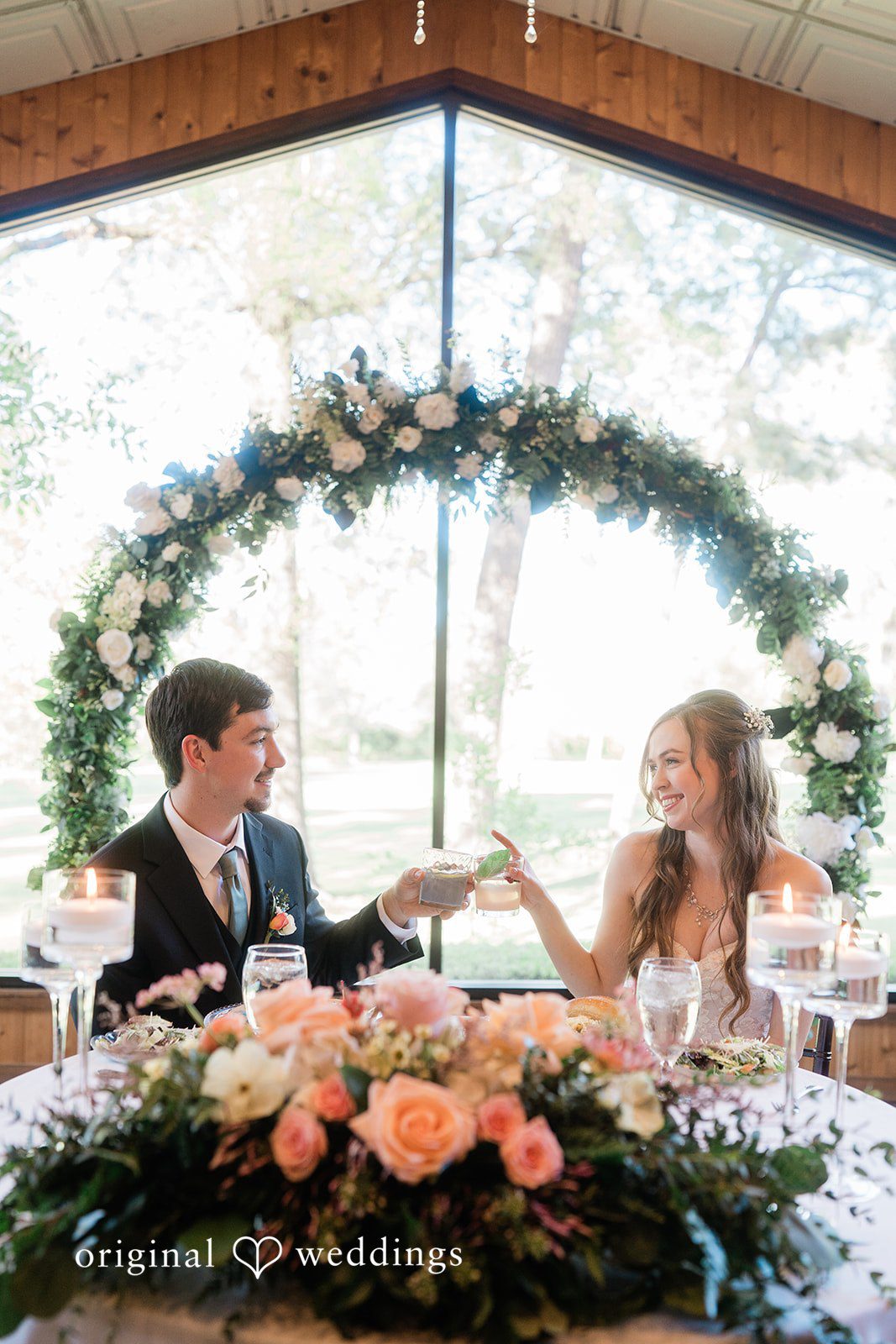 The couple shares a toast at their wedding reception