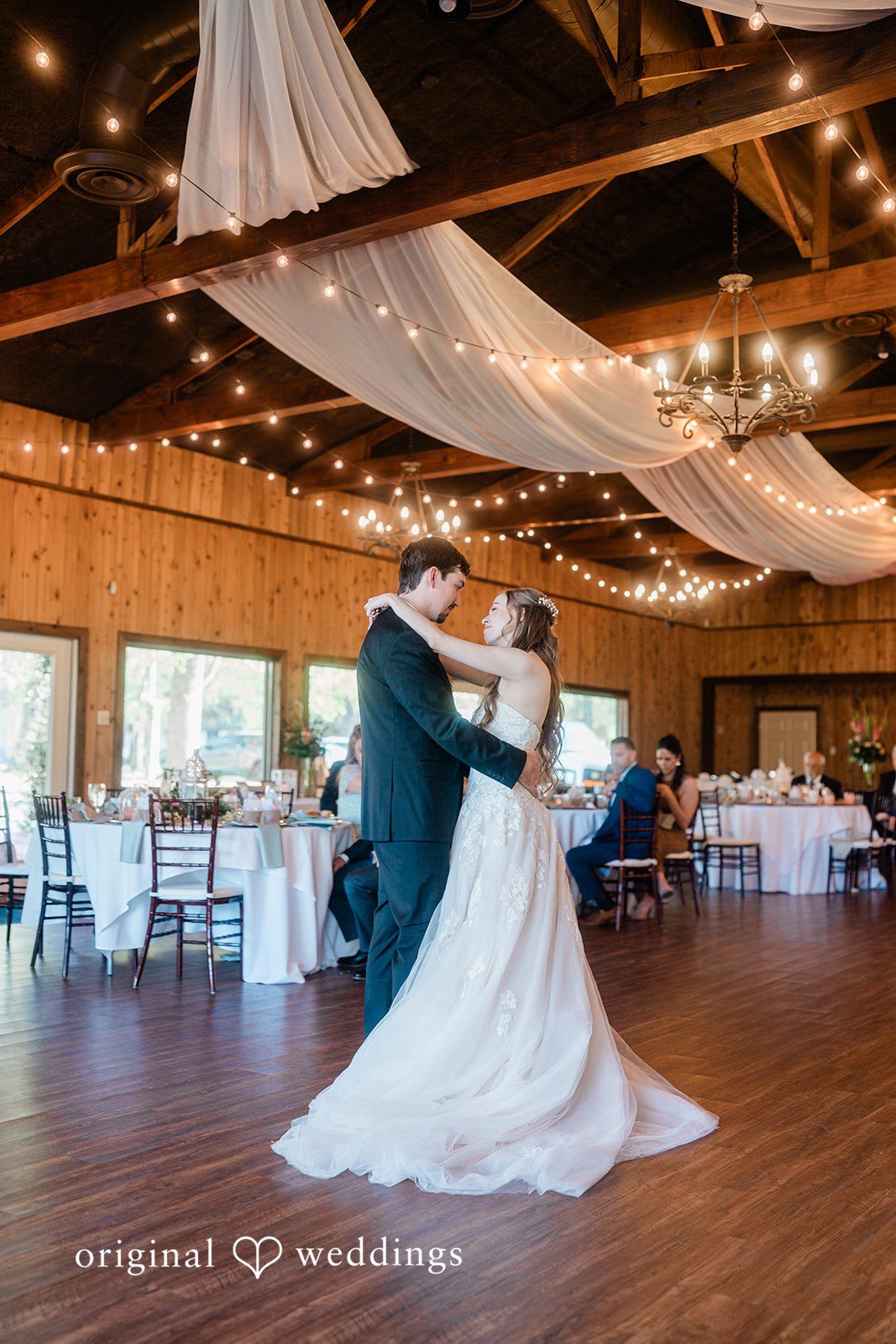 The couple takes their first dance at their wedding reception