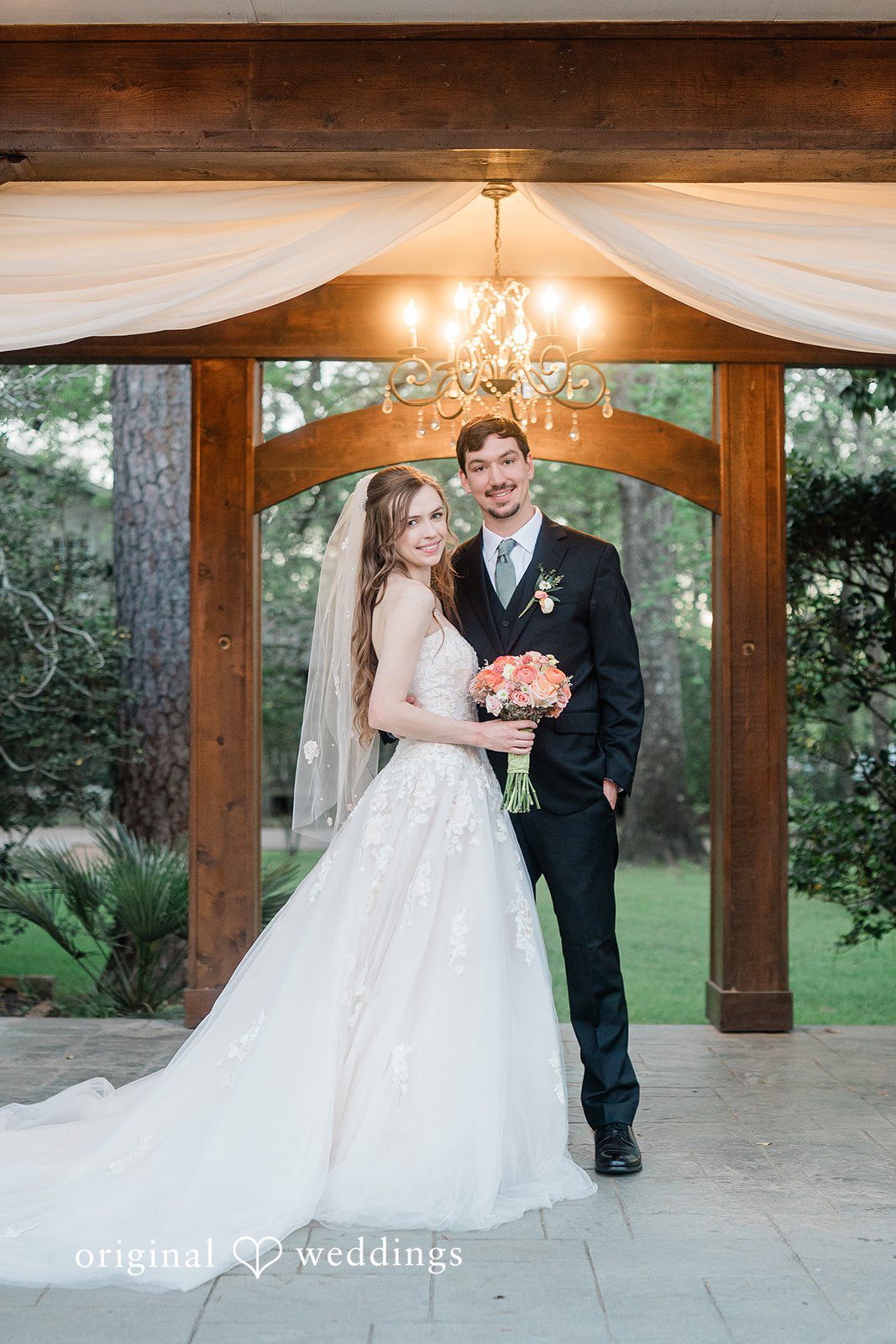 A stunning portrait of the couple by the arbor