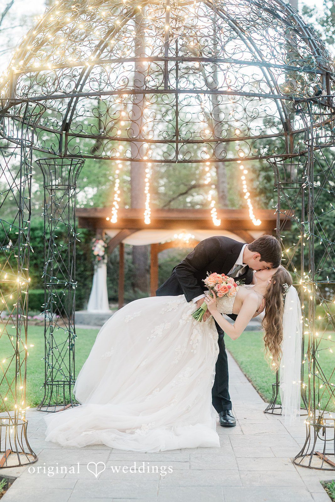 A romantic portrait of the couple in the gazebo