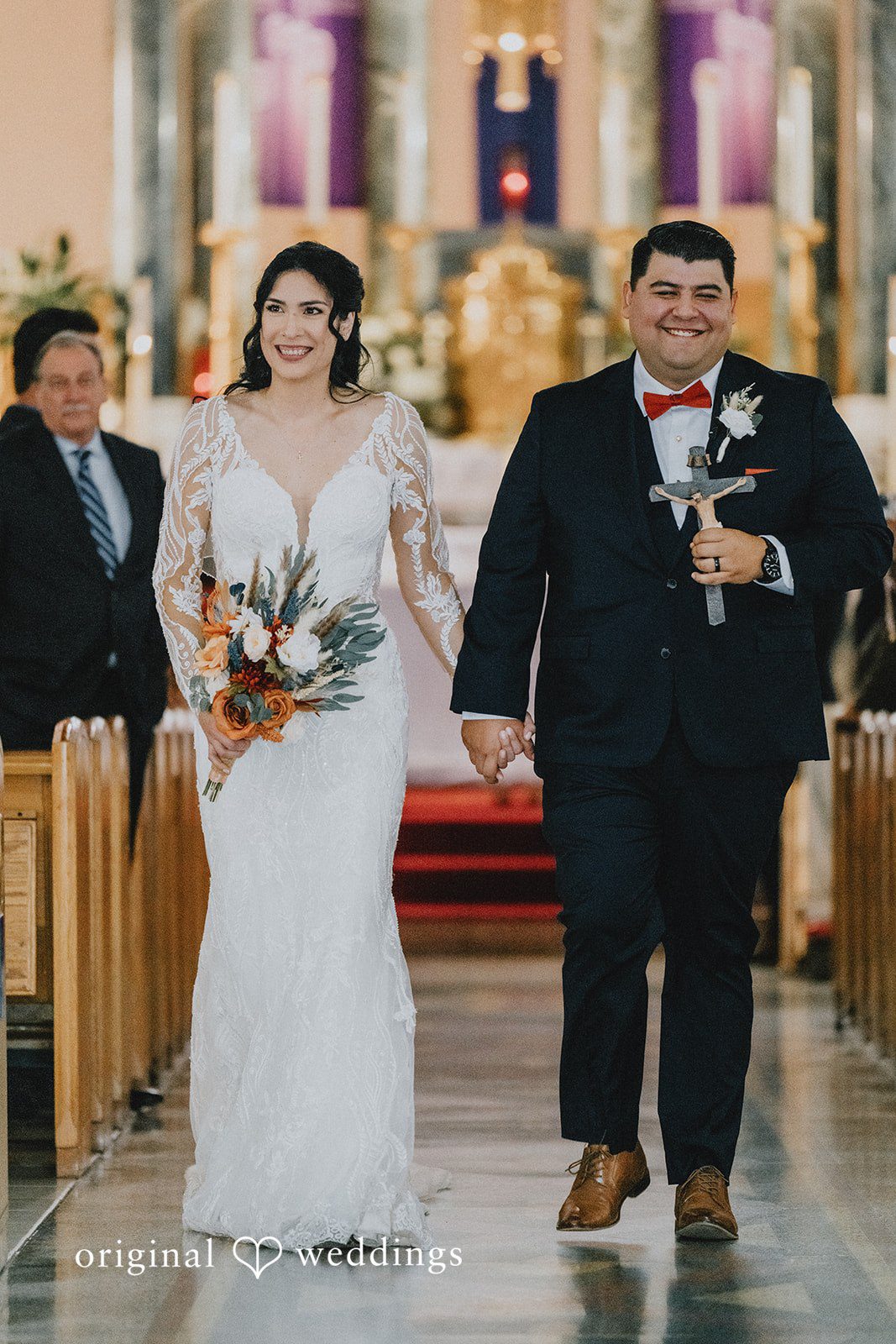 Couple leaving after ceremony walking hands in hands