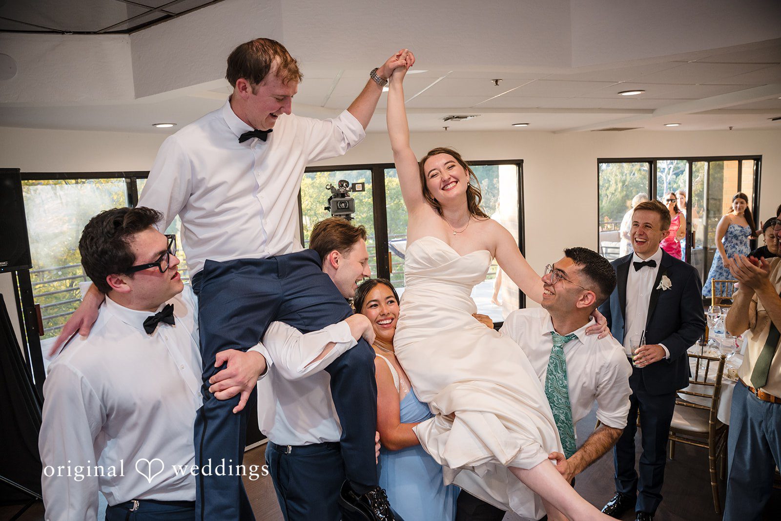 Couple and guests celebrating together during the reception party