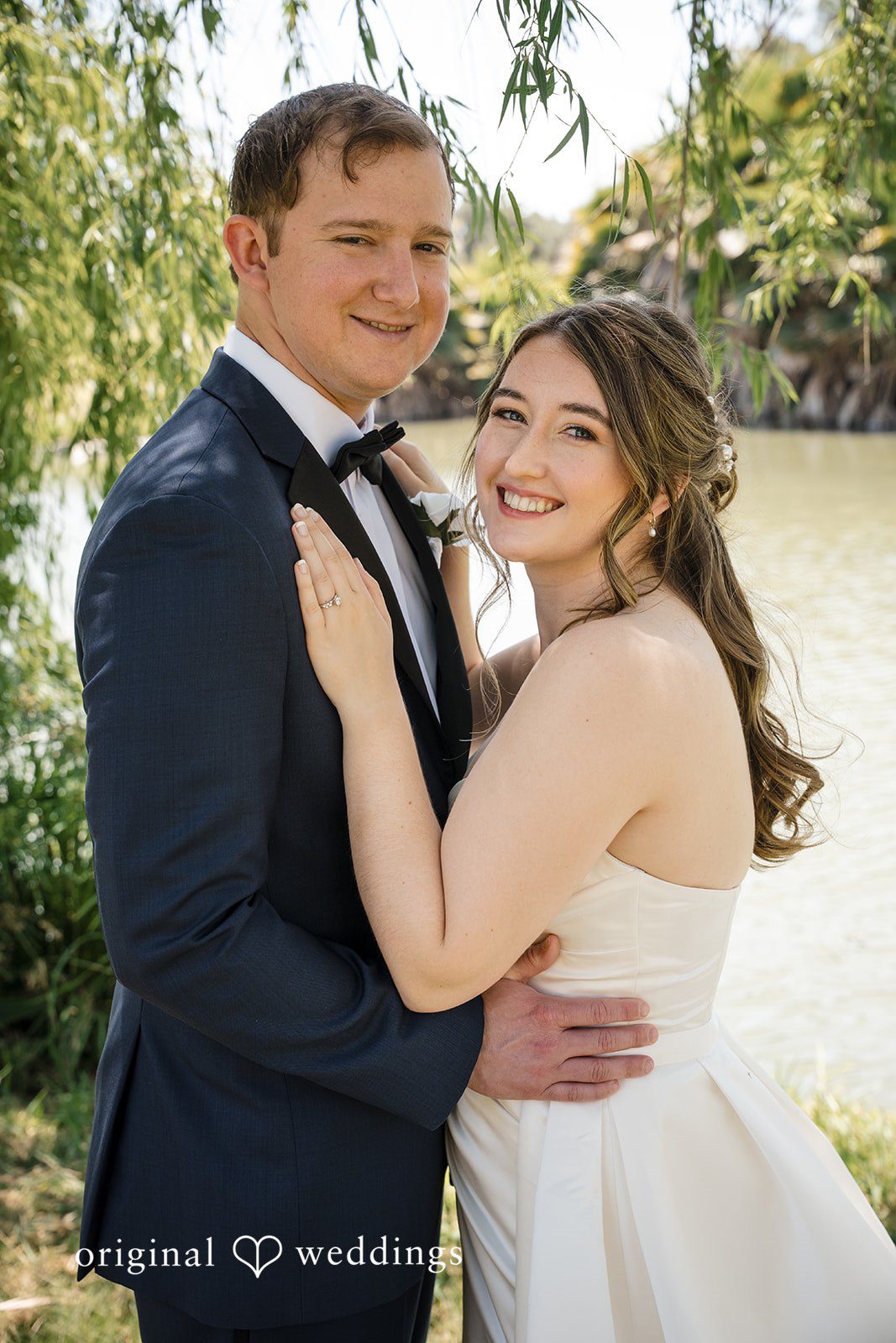 Couple embracing during romantic outdoor wedding portraits