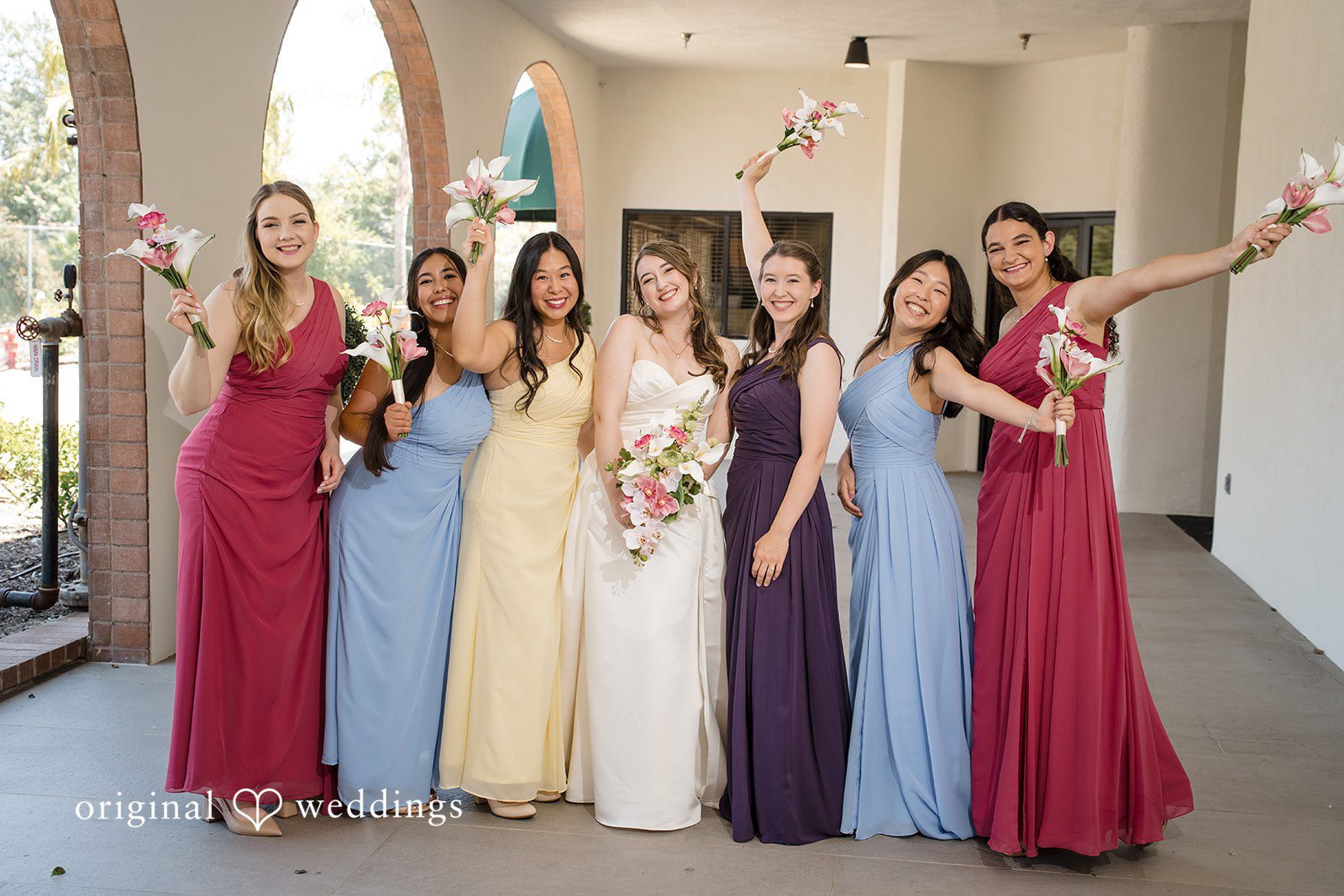 Bride posing with bridesmaids before the ceremony