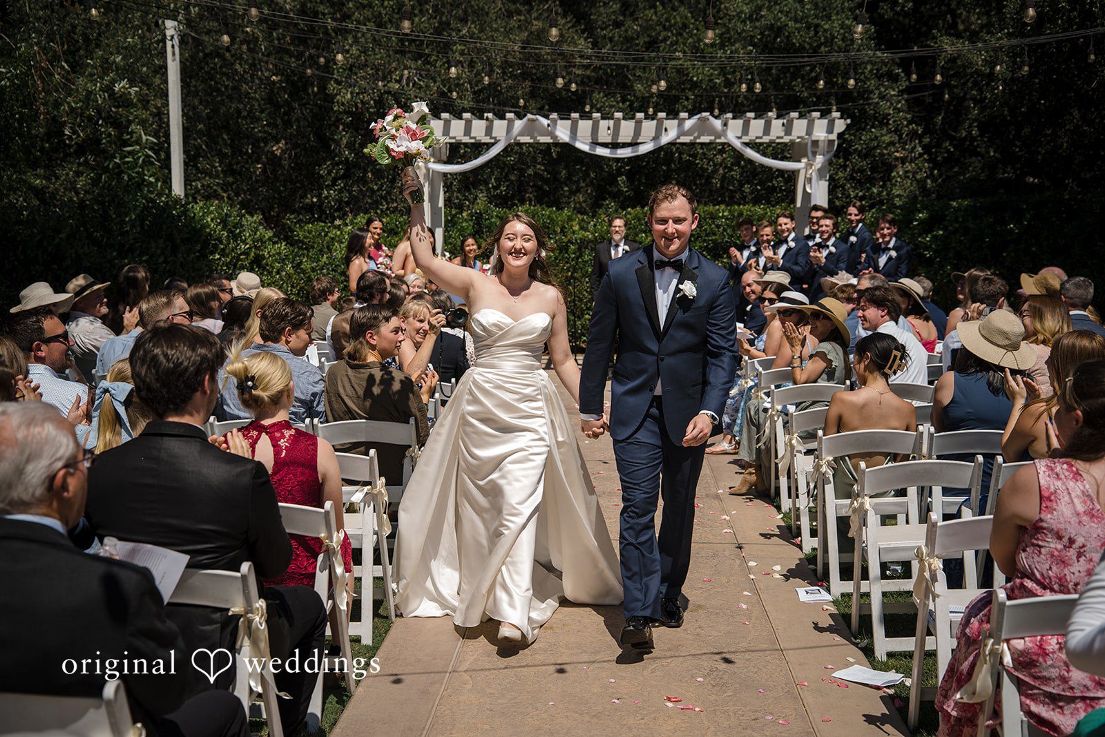 Newlyweds walking away from the ceremony together
