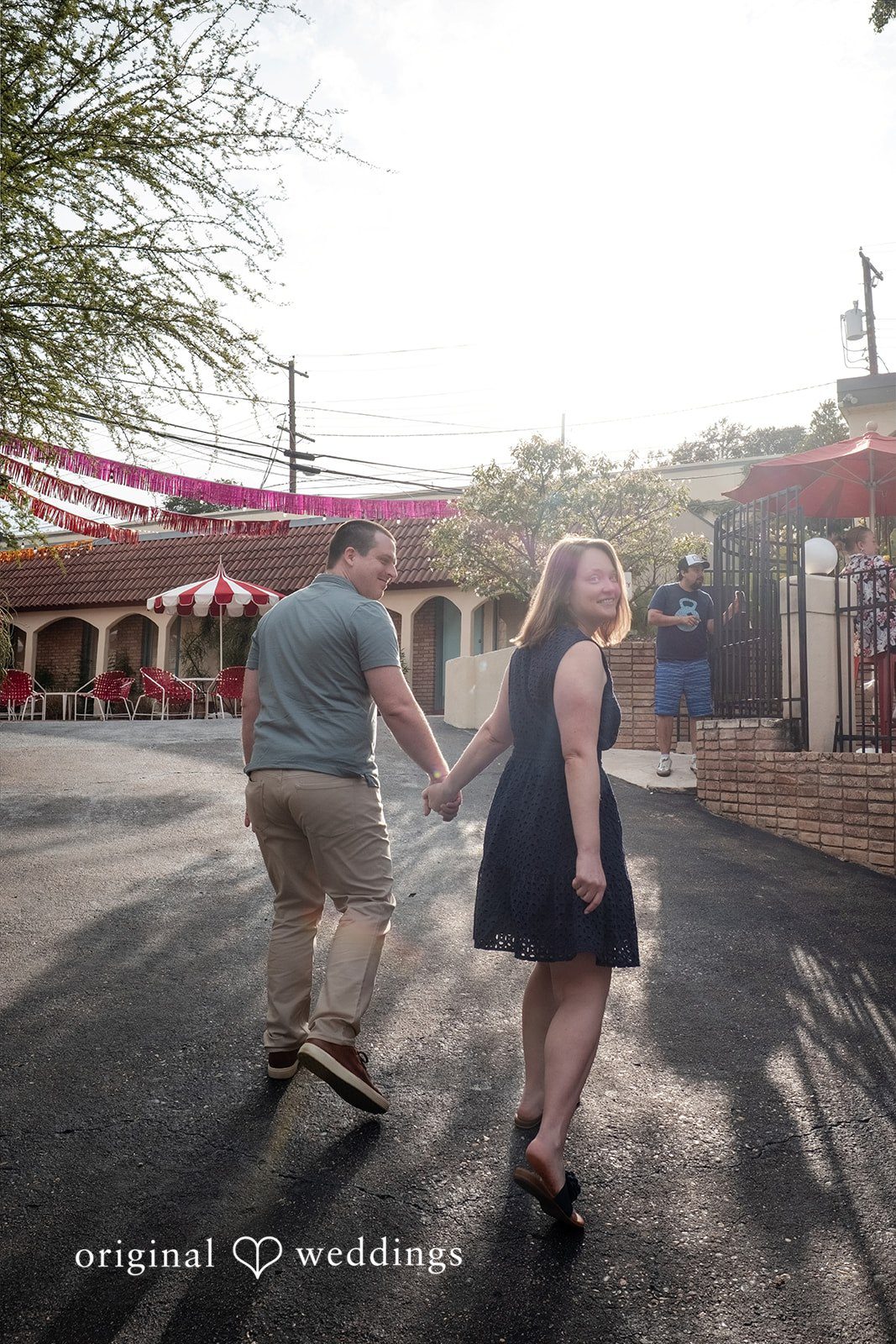 Eric + Kimberly Engaged couple walking hand in hand during their South Congress engagement session