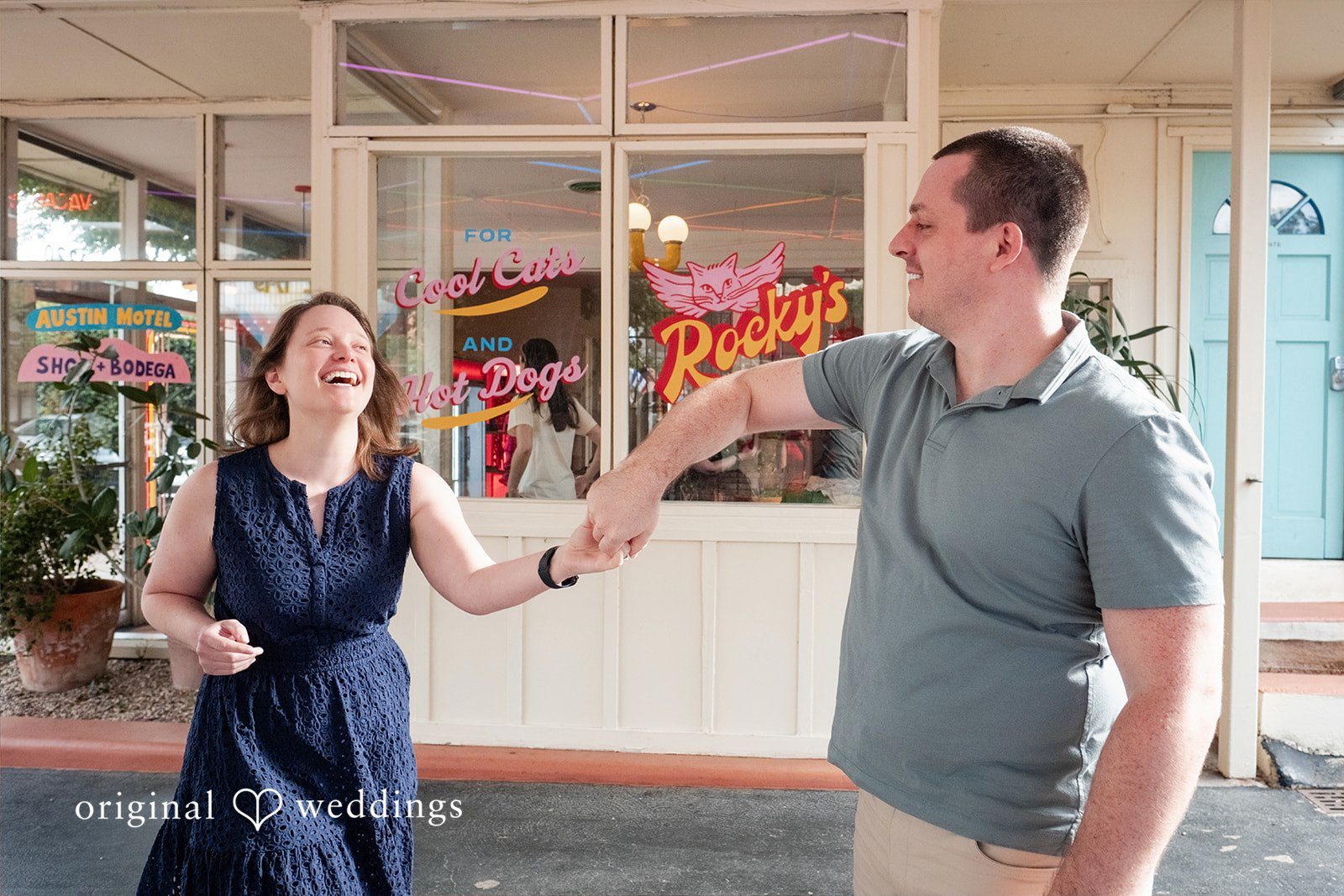 Eric + Kimberly Couple laughing together while holding hands at South Congress Captured by Austin Engagement Photographers from Original Weddings