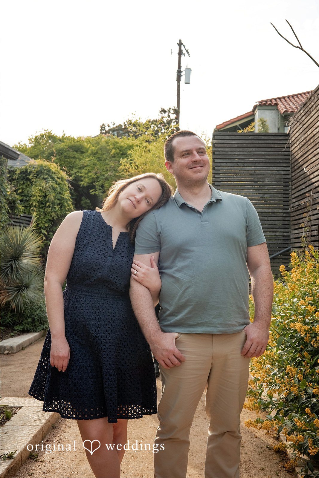 Eric + Kimberly Engaged couple standing together in a garden