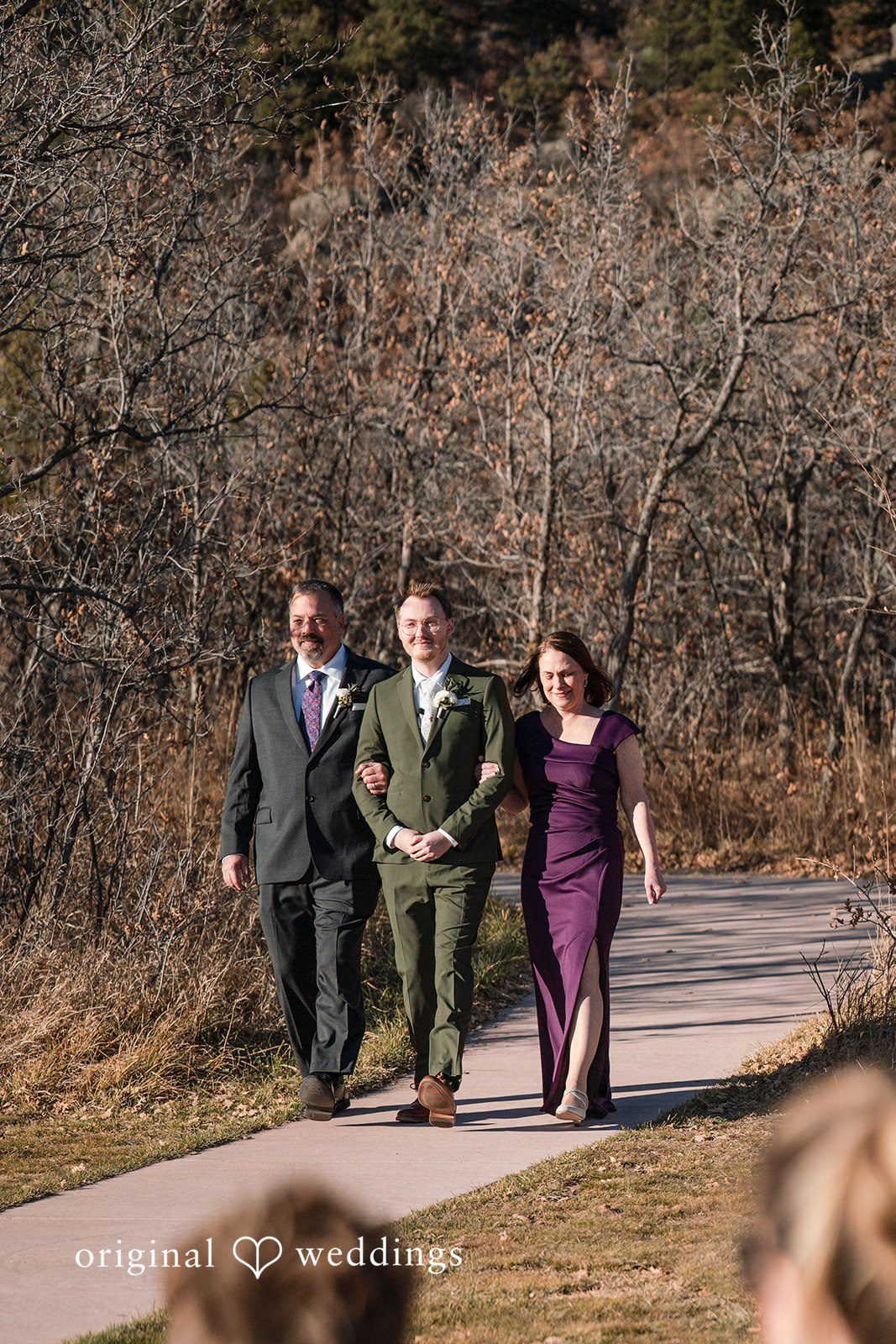 Groom walking to the ceremony with his parents