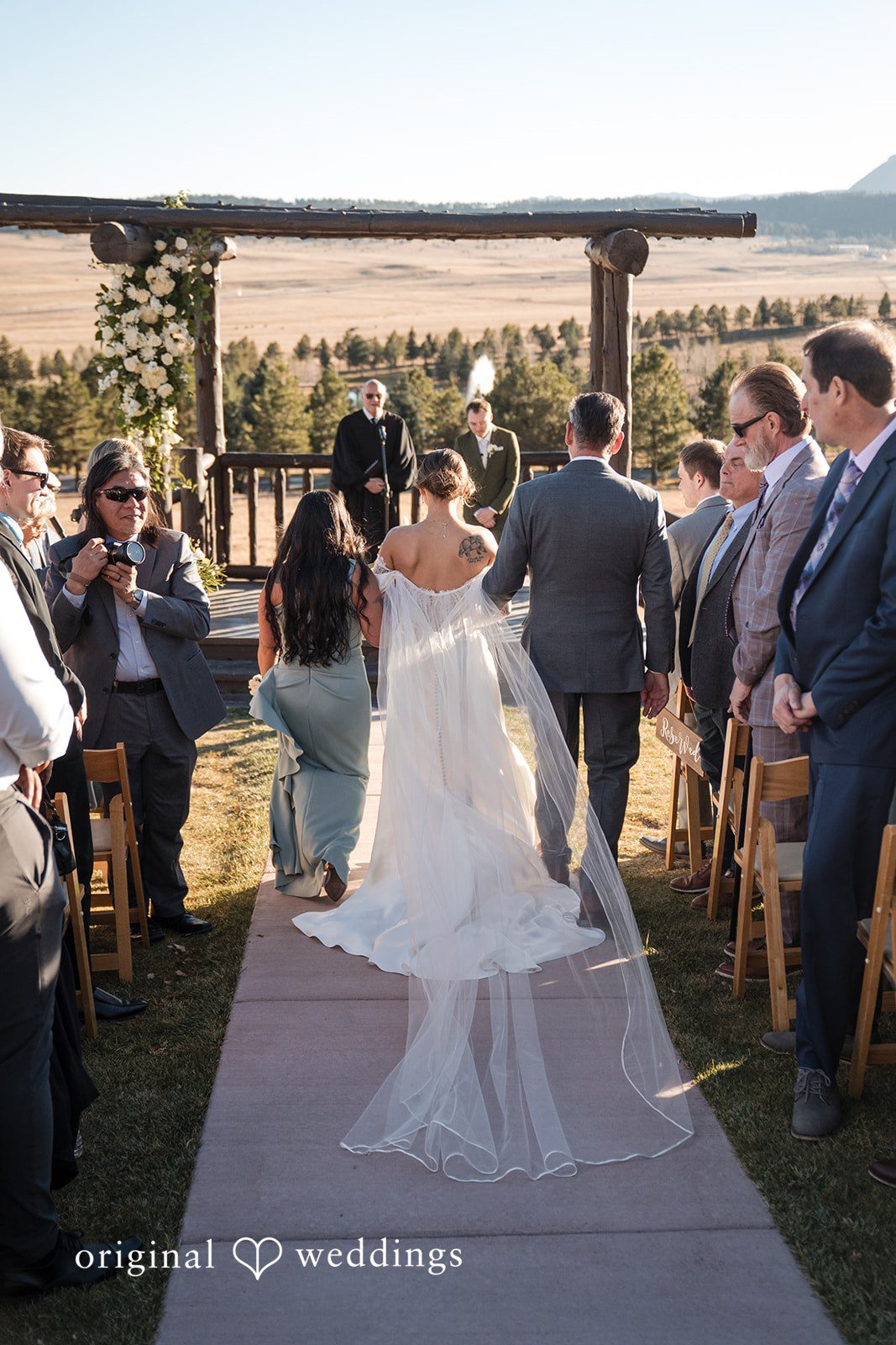 Bride entering the ceremony with her parents