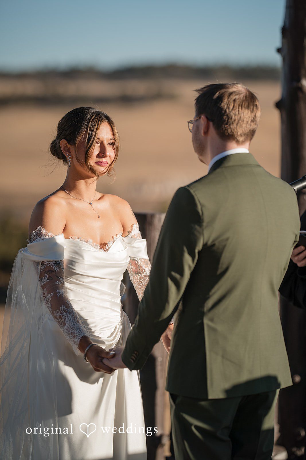 Groom facing away while the bride stands during the ceremony