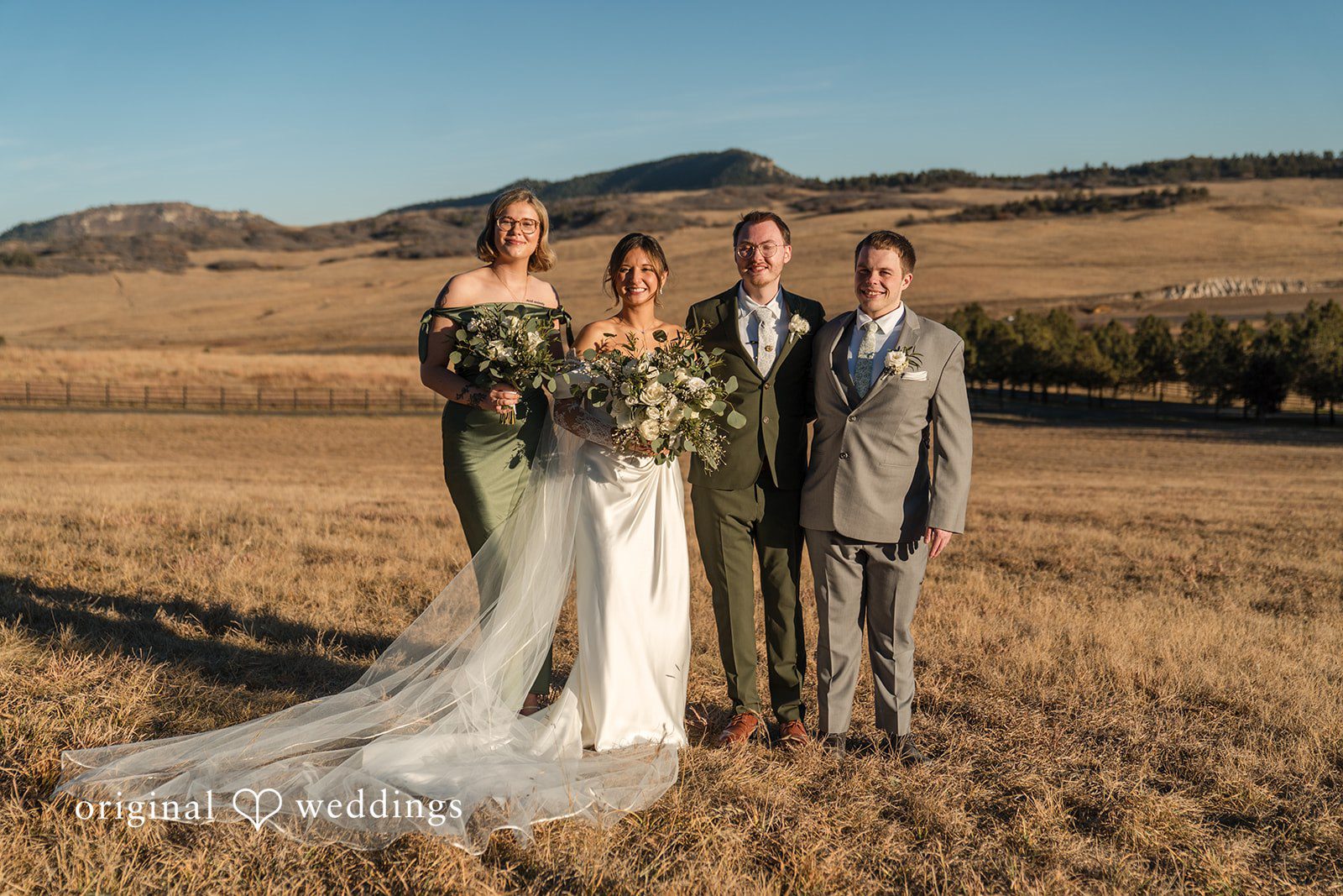 Bride and groom posing with friends during the wedding celebration