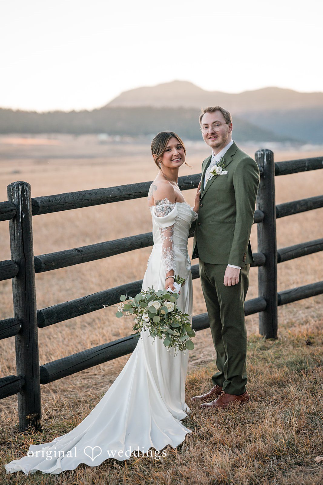 Full-length portrait of the couple in a rustic outdoor setting