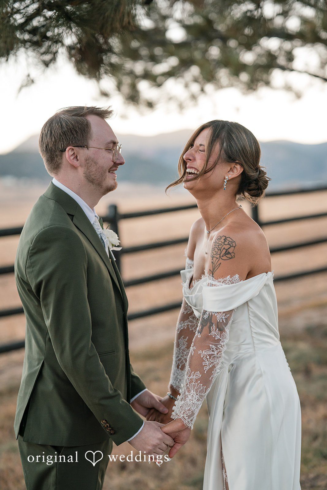 Bride and groom laughing together during outdoor portraits