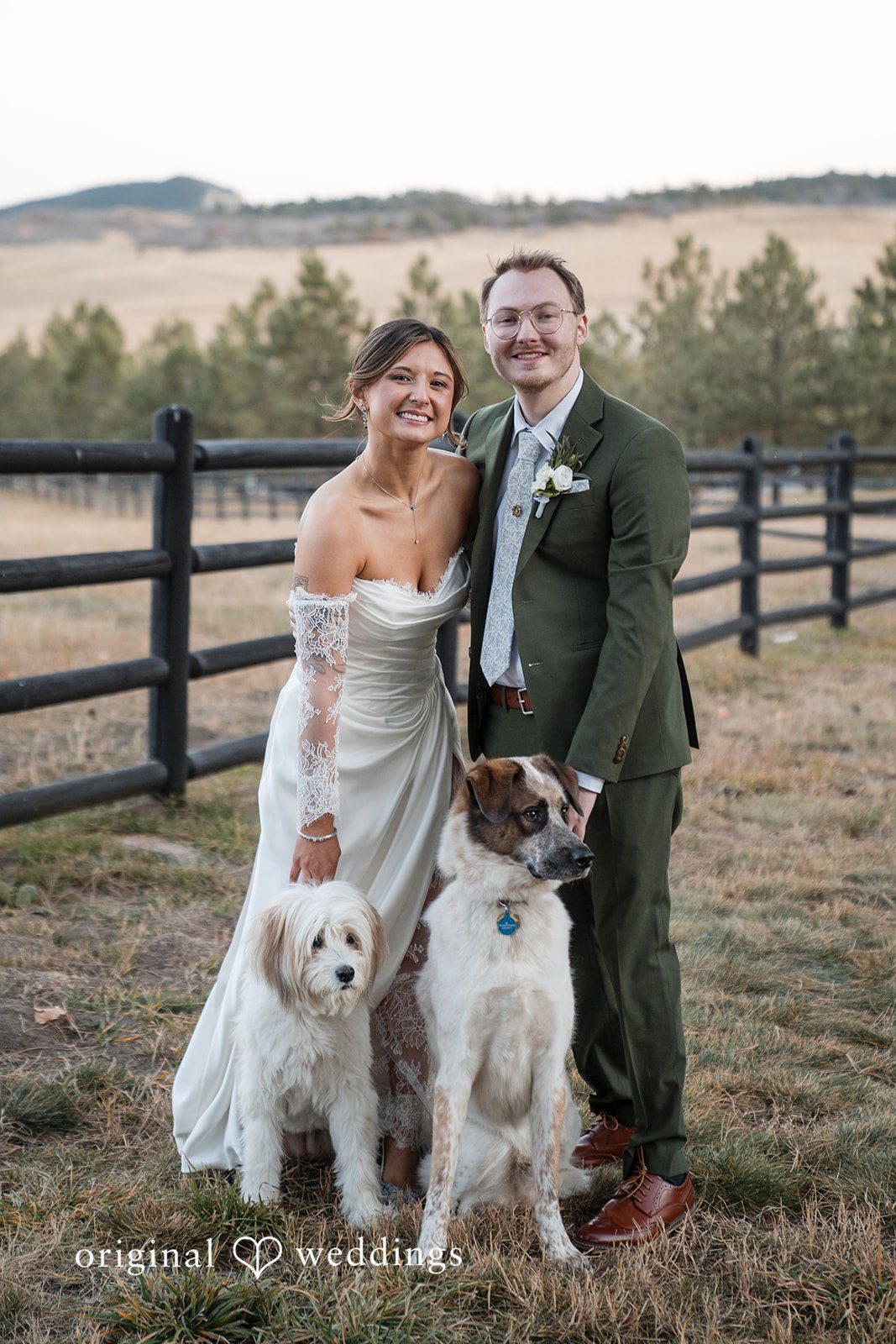 Bride and groom posing with their dog during wedding portraits