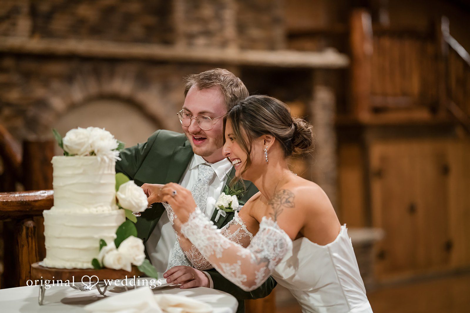 Bride and groom cutting their wedding cake together