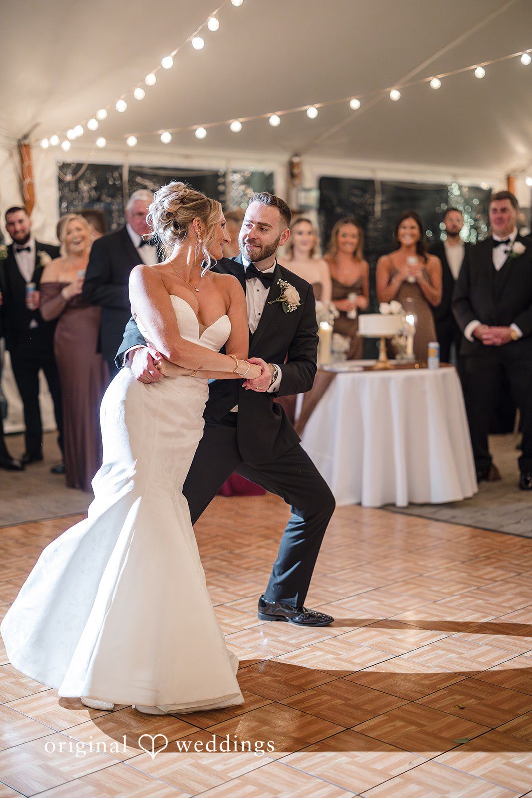 Laura + Nicholas Bride and groom sharing romantic first dance during elegant wedding reception celebration at Stevens Estate at Osgood Hill
