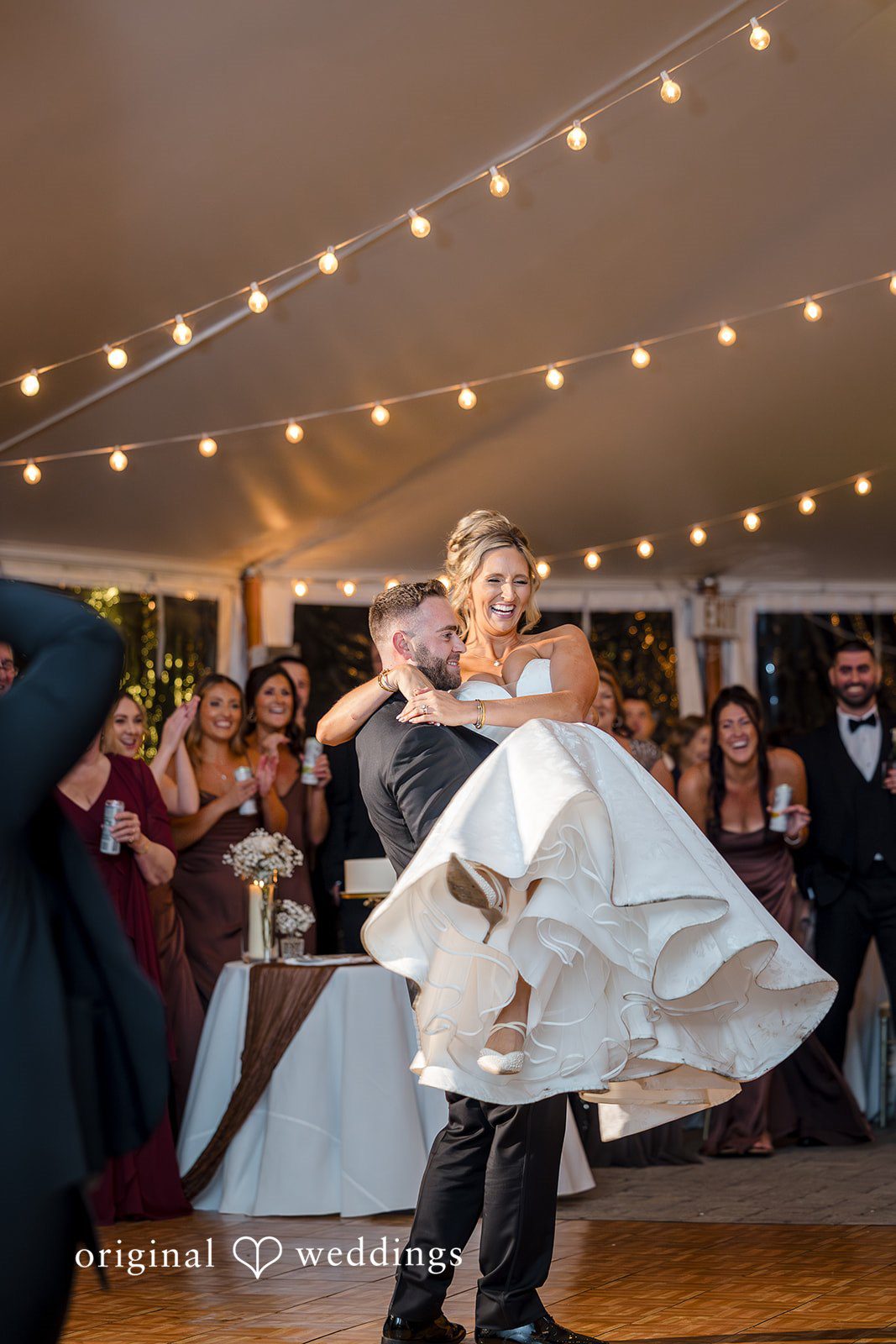 Laura + Nicholas Groom lifting bride during energetic wedding reception dance