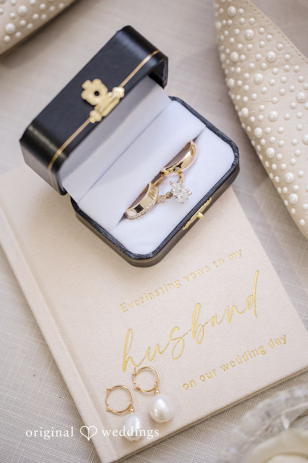 Laura + Nicholas Beautiful wedding ring detail shot with elegant styling and soft lighting