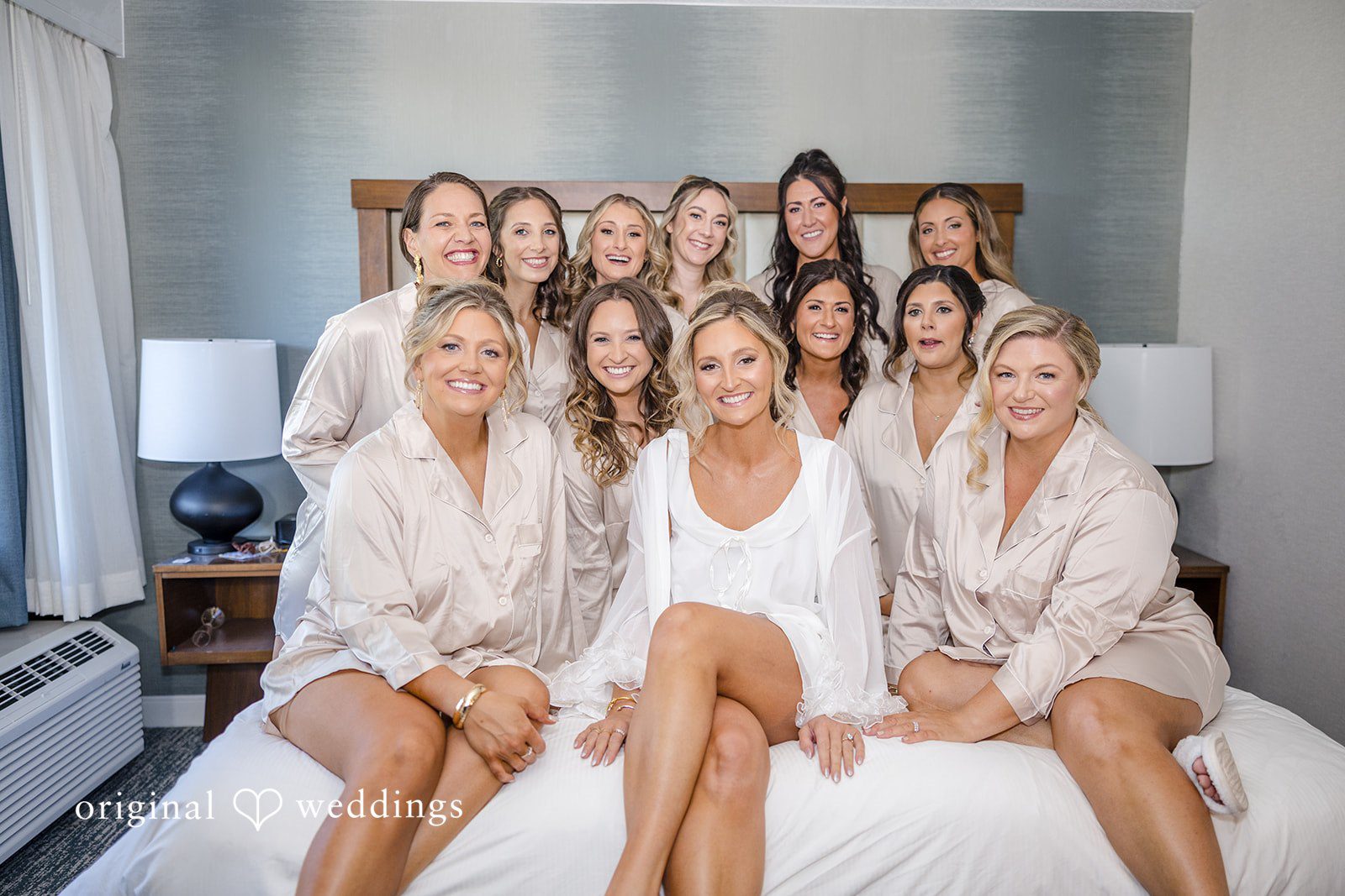Laura + Nicholas Bride sharing joyful moments with bridesmaids before wedding ceremony