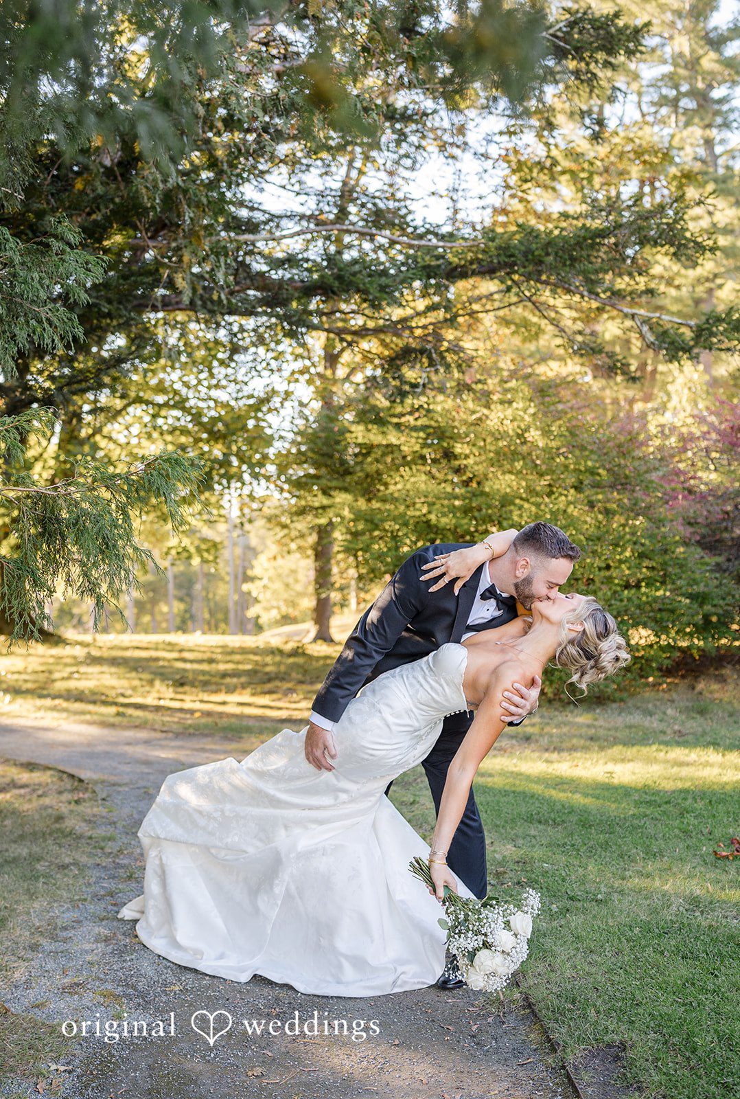 Laura + Nicholas Romantic moment of bride and groom kissing after wedding ceremony at Stevens Estate at Osgood Hill