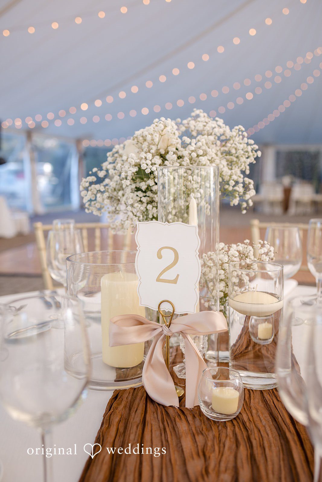 Laura + Nicholas Elegant reception decor with candlelight and floral arrangements