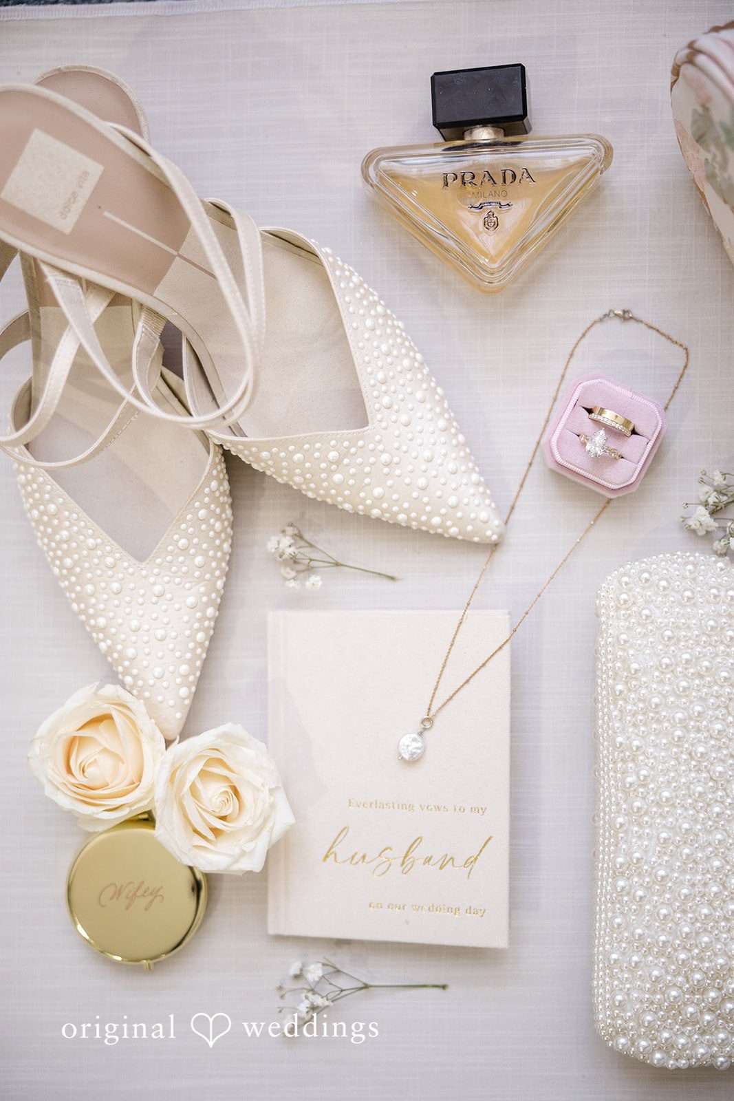 Laura + Nicholas Elegant bridal wedding accessories including pearl heels, wedding rings, perfume, and jewelry