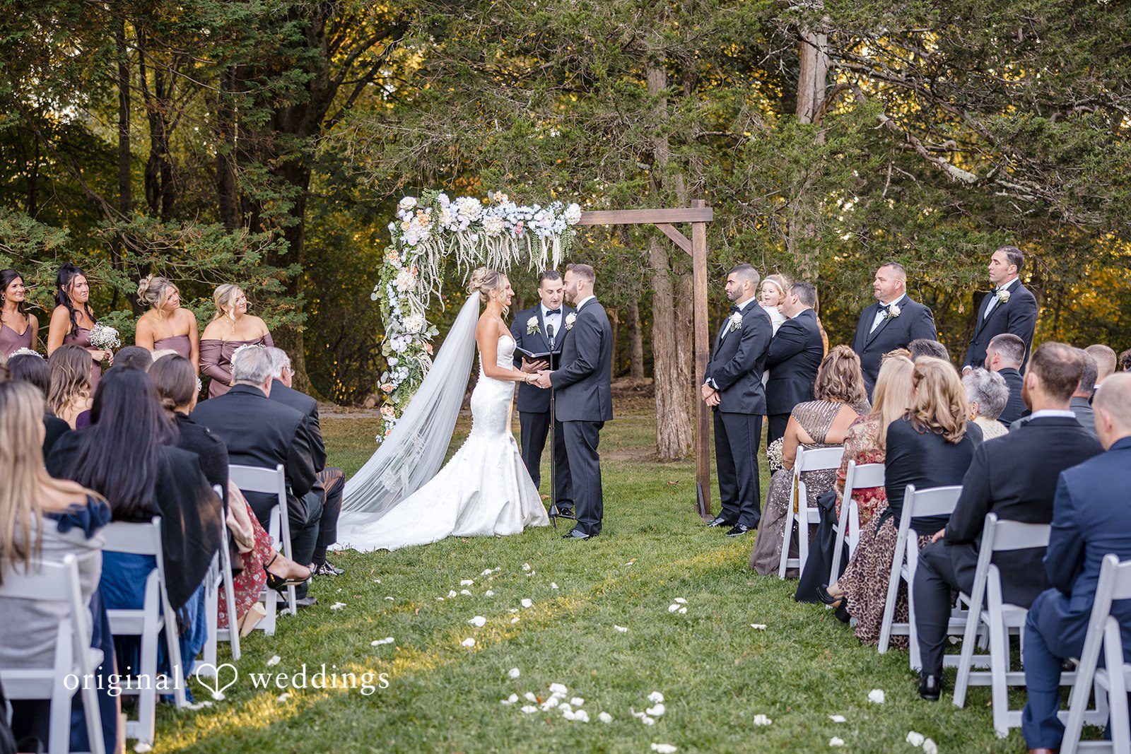 Laura + Nicholas Bride and groom holding hands during romantic vow exchange