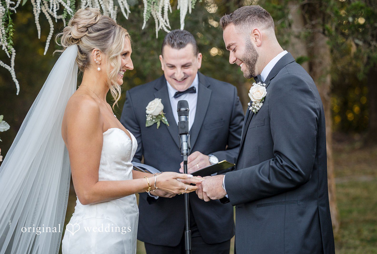 Boston Wedding Photographers by Original Weddings capturing bride and groom exchanging wedding rings during the ceremony at Stevens Estate at Osgood Hill