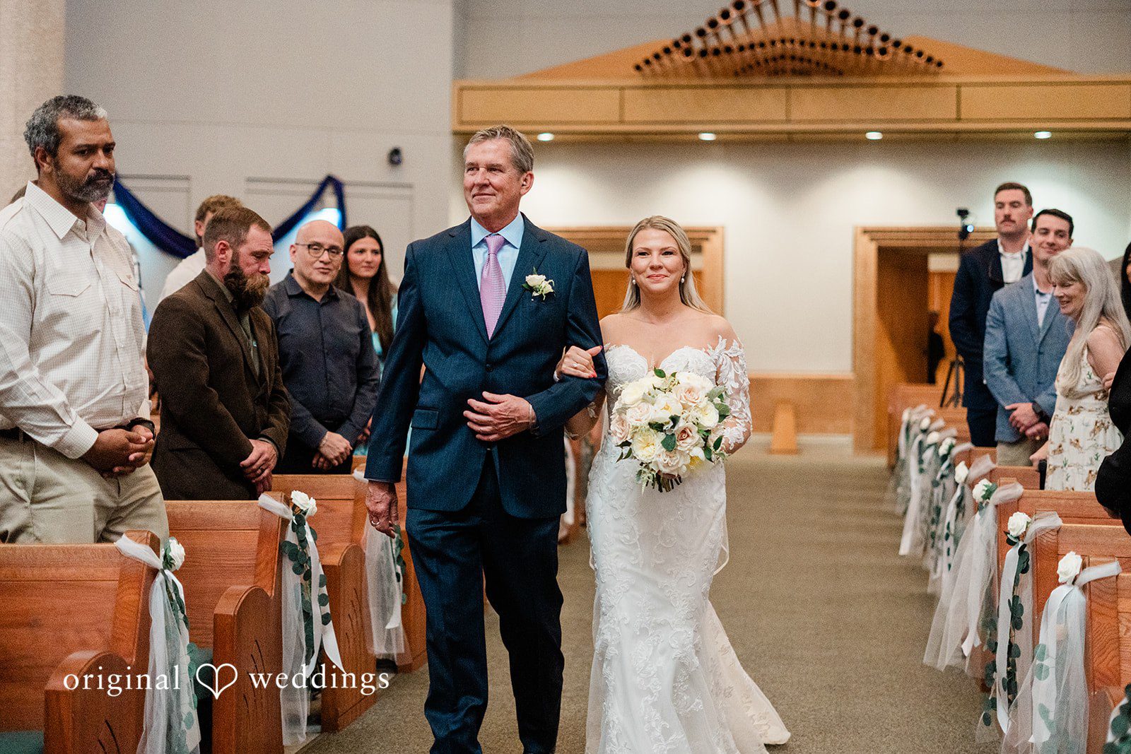 The bride's father walks bride down the aisle