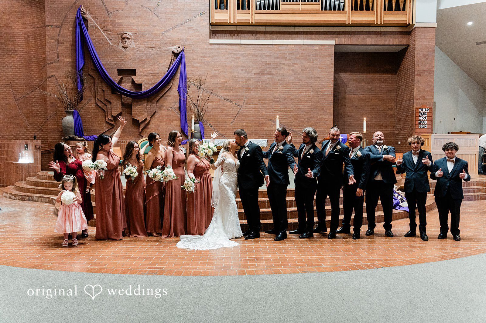 Our St. Antonio wedding photographers at Original Weddings captured a romantic portrait of the couple and their bridal party at St.Mark Evangelist Catholic Church