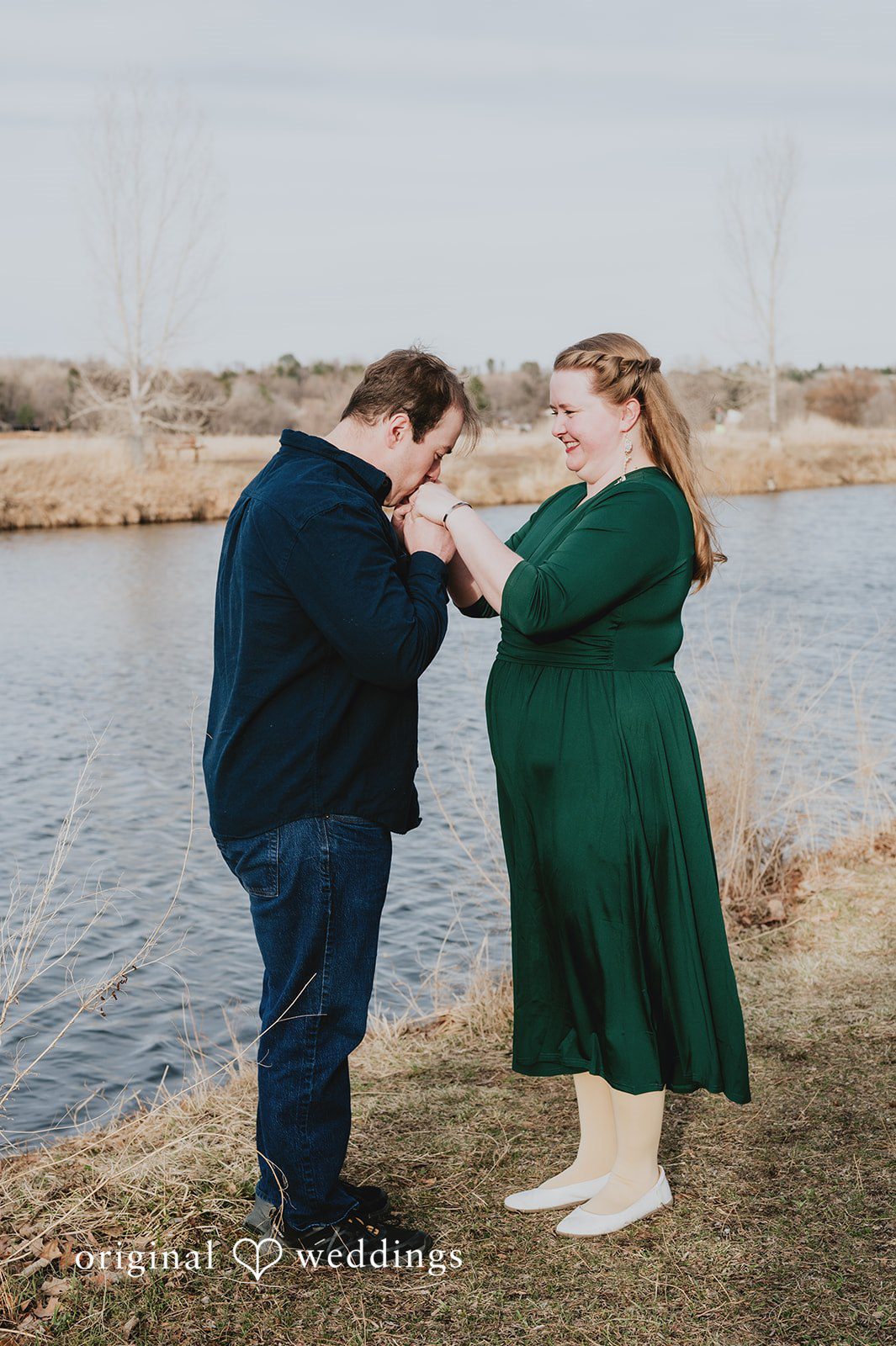 Beautiful pose of couple captured while groom to be kissing on hand of bride to be