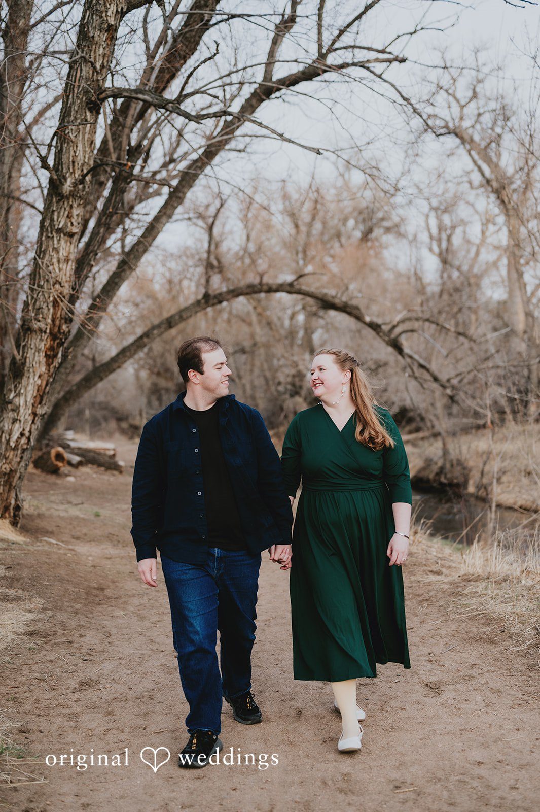 Couple walking hands in hands during session