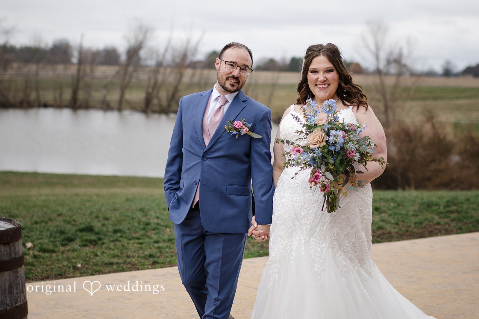 Katrena + Ryan Bride and groom holding hands during romantic portraits