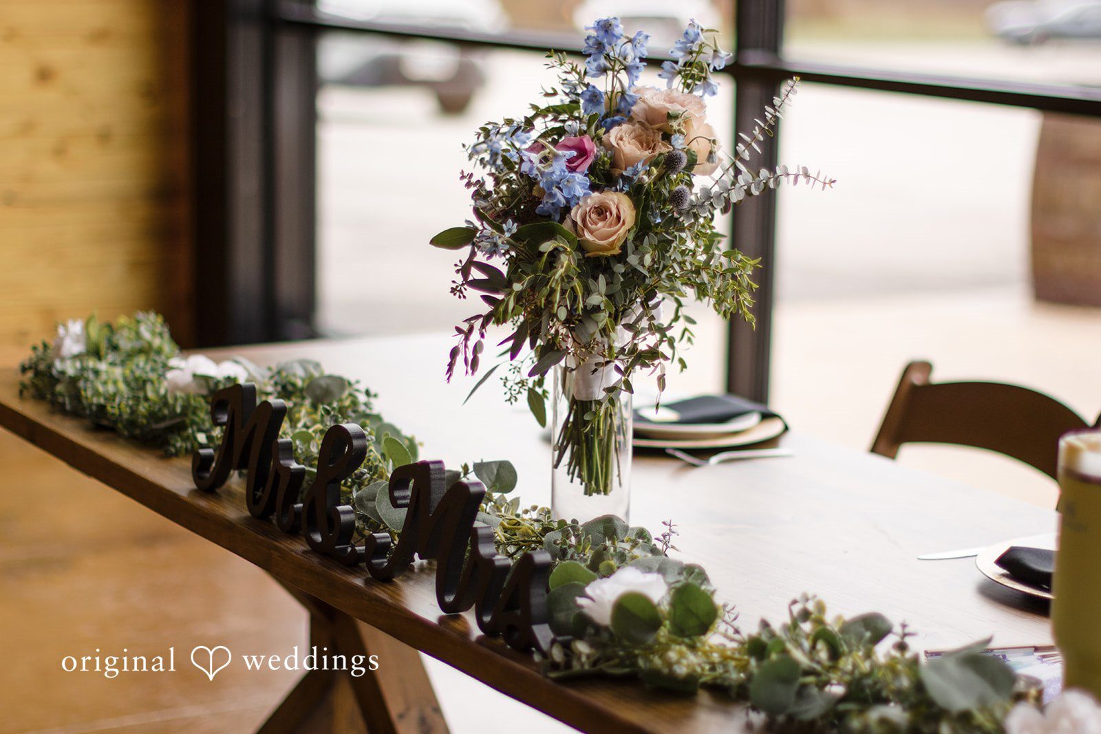 Katrena + Ryan Close-up of floral centerpiece decor on the reception table